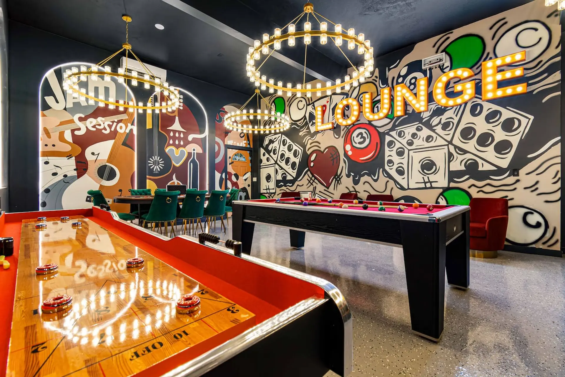 A game room with a pool table, shuffleboard, and lounge seating.