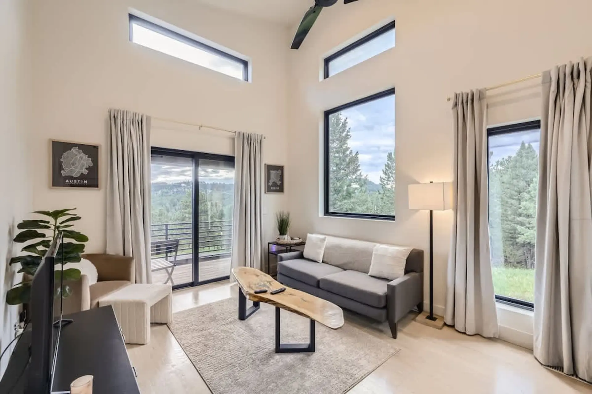 Living room with couch, coffee table, and large windows.