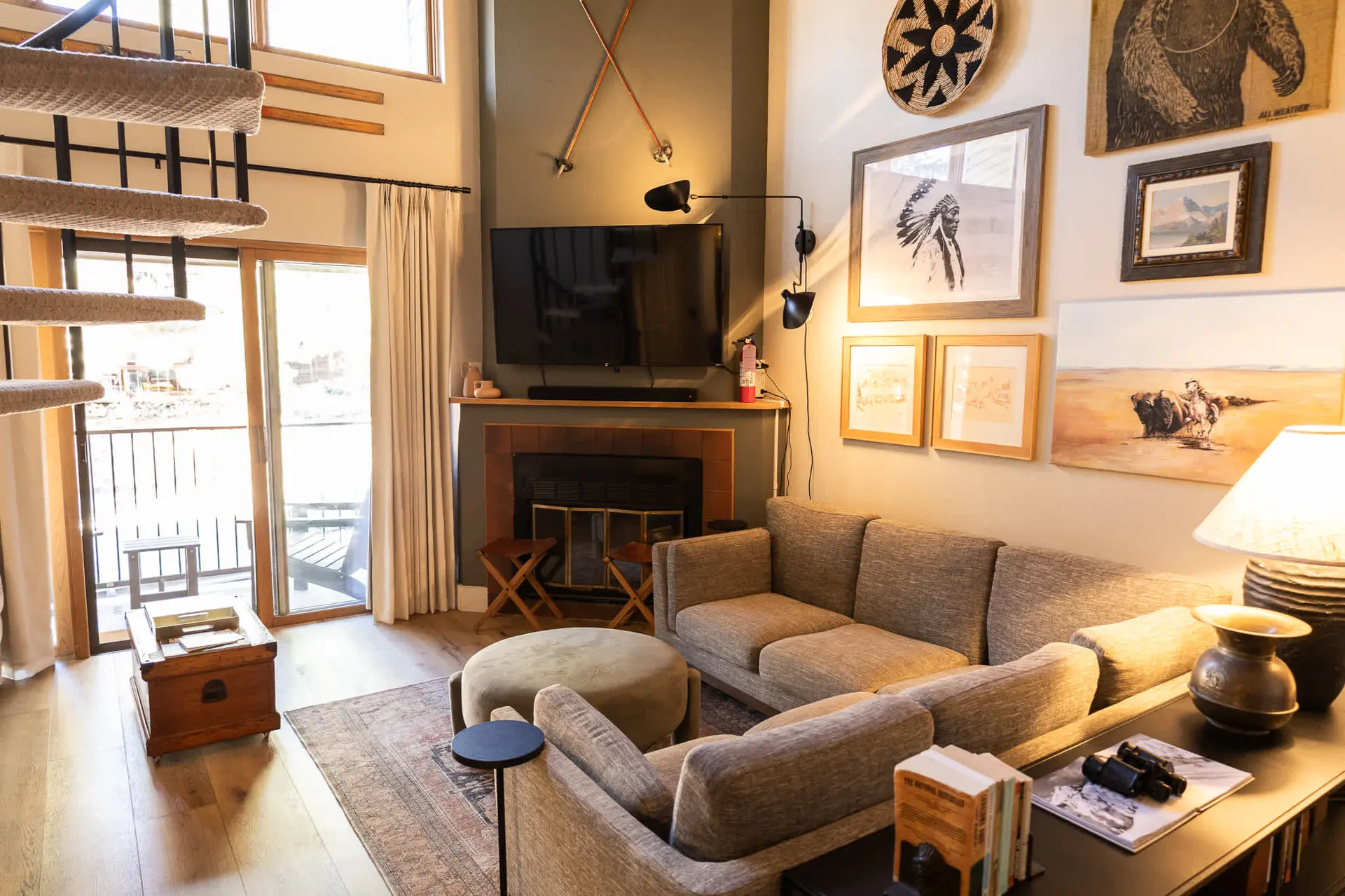 Living room with fireplace, couch, and staircase.