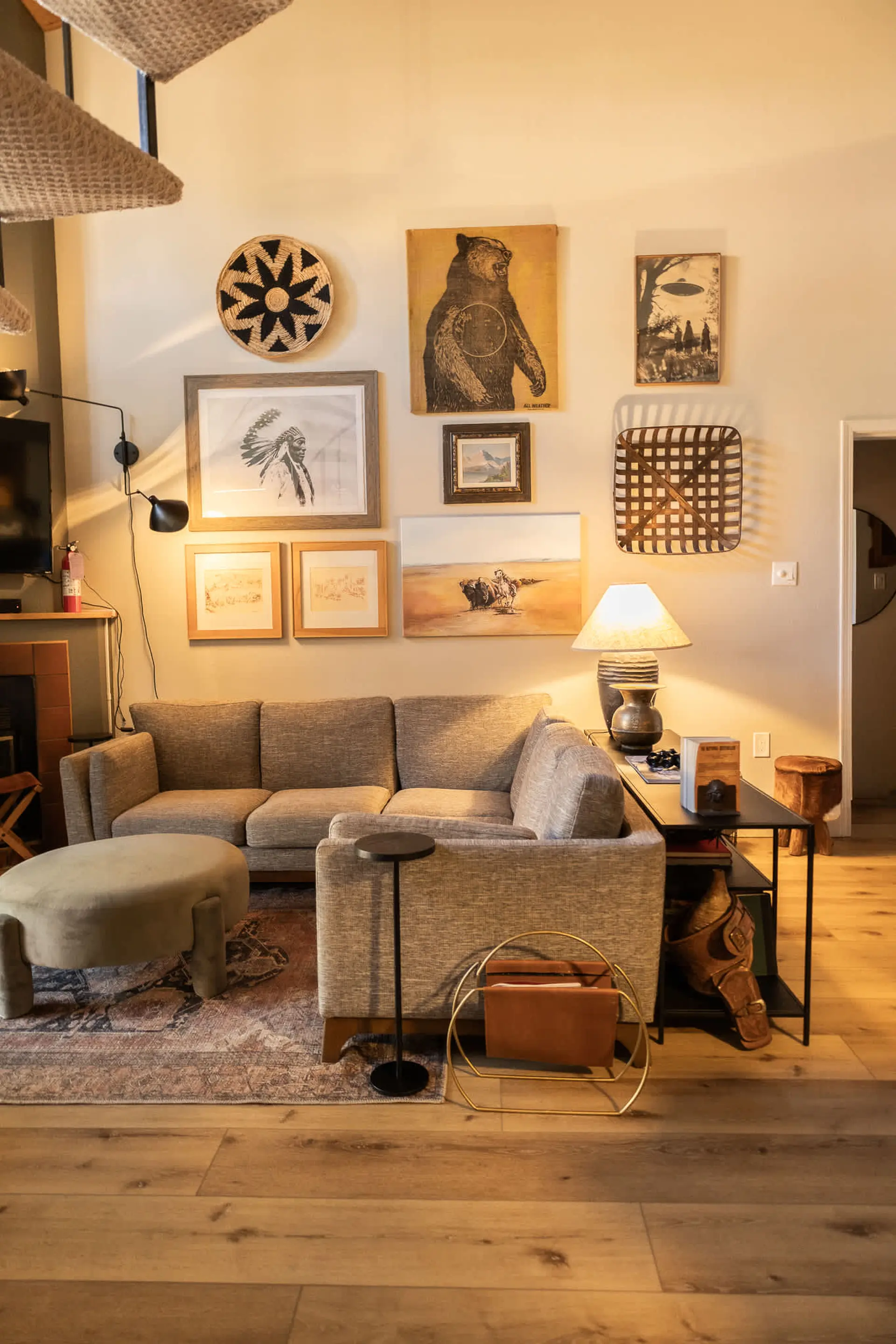 Living room with sectional couch, ottoman, and wall decor.