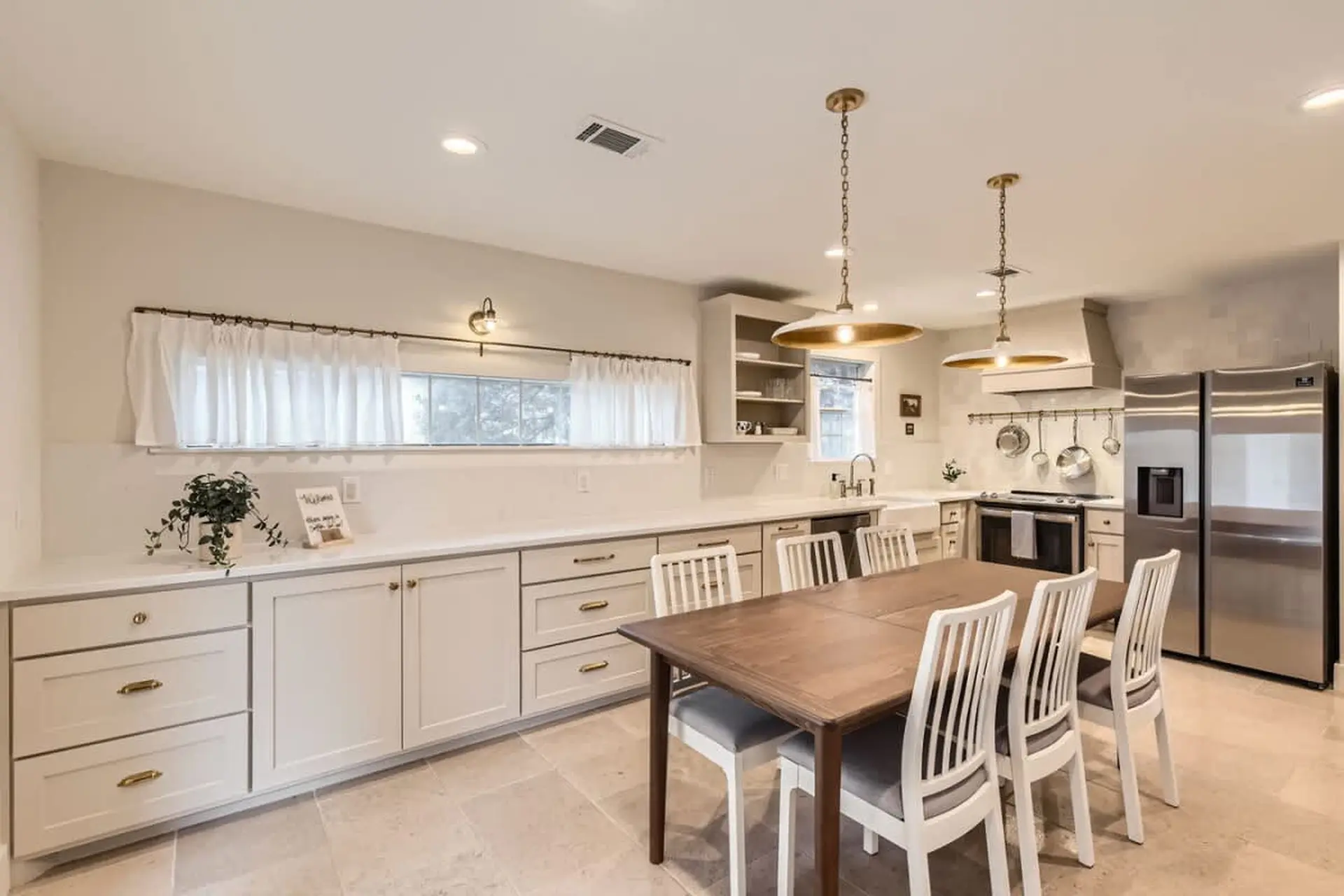 A modern kitchen with a dining table and chairs.