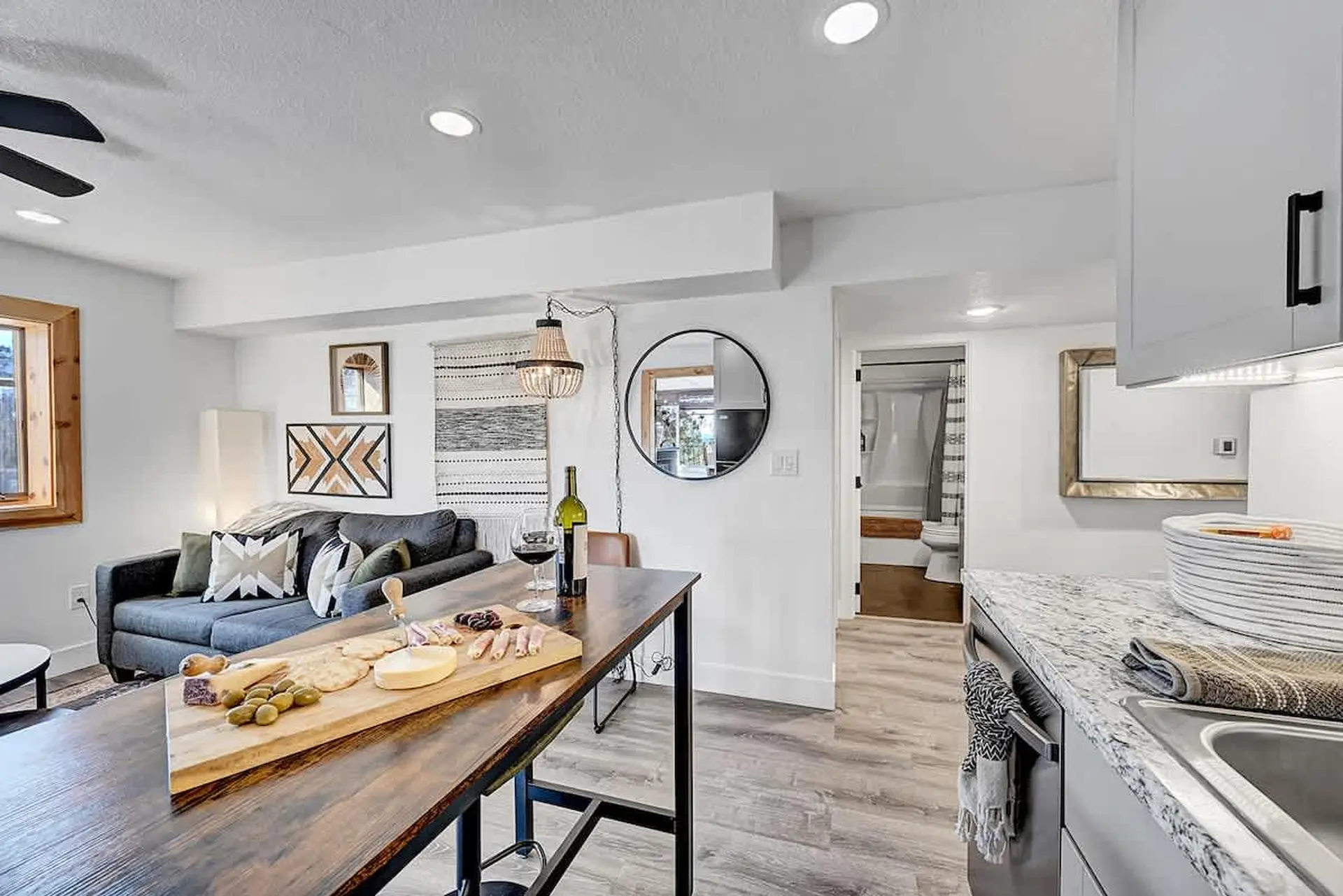 Modern open-plan living area with dining, kitchen, and bathroom.