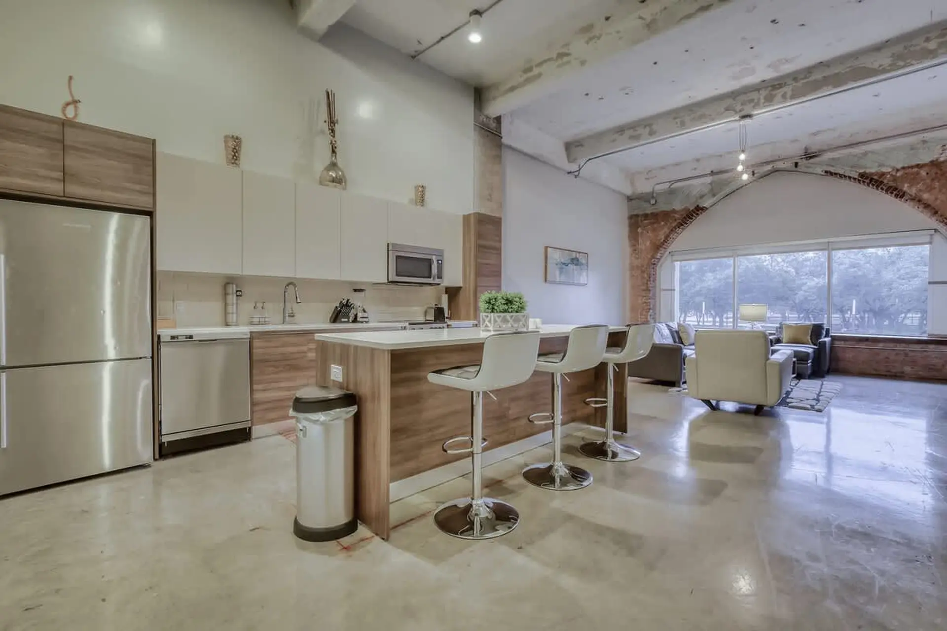 Modern loft kitchen and living area with industrial accents.