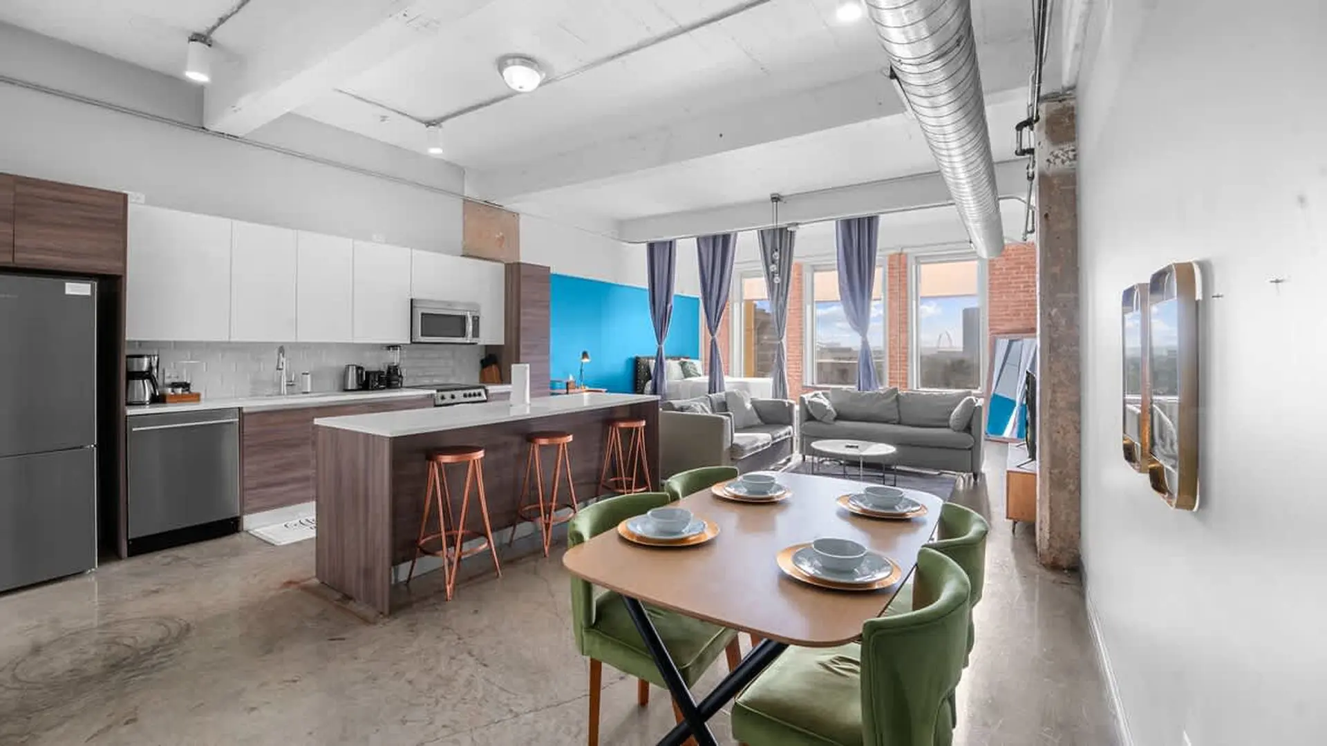 Loft apartment with kitchen, dining area, and living room.