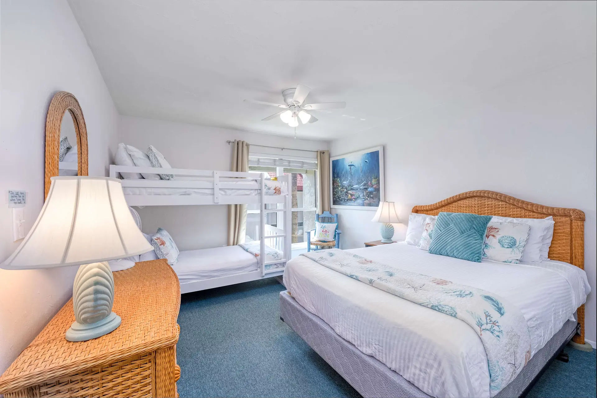 A bedroom with bunk beds and a king-size bed.