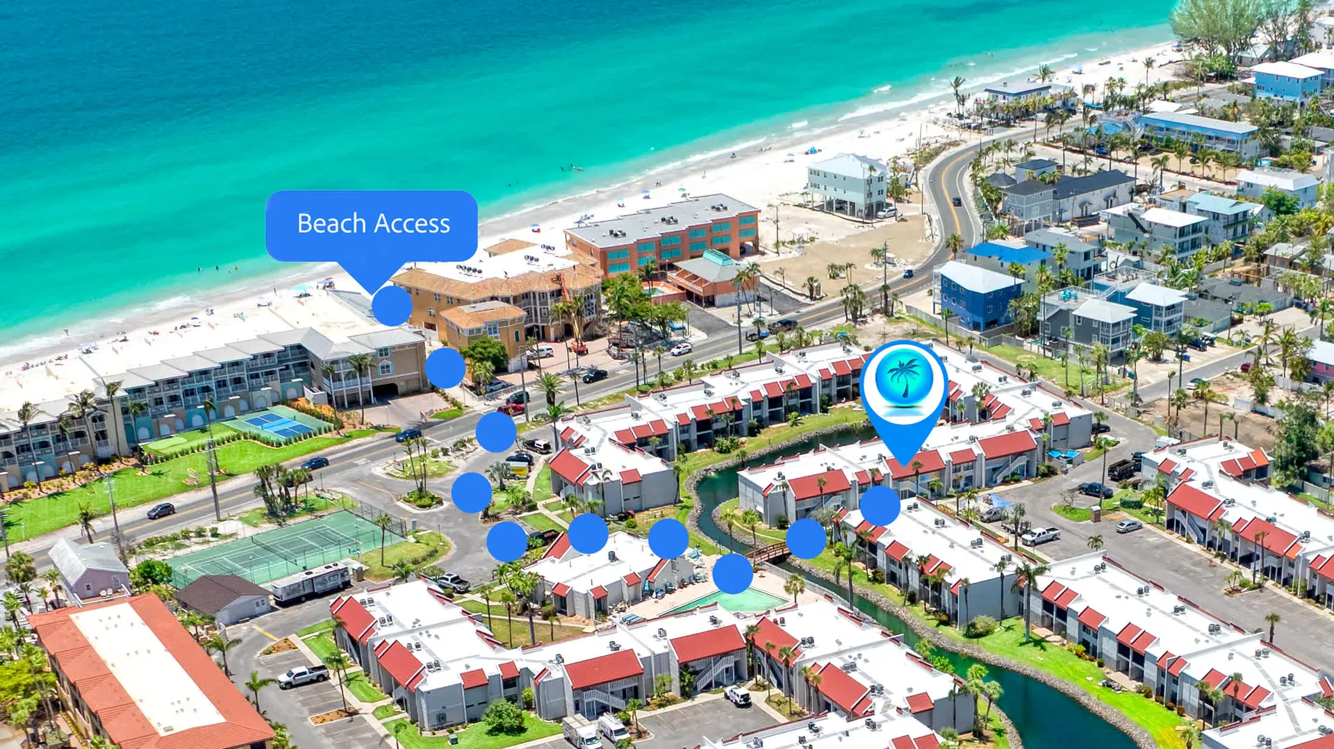 An aerial view of a beach resort with buildings, pools, tennis courts, and a road leading to the bea