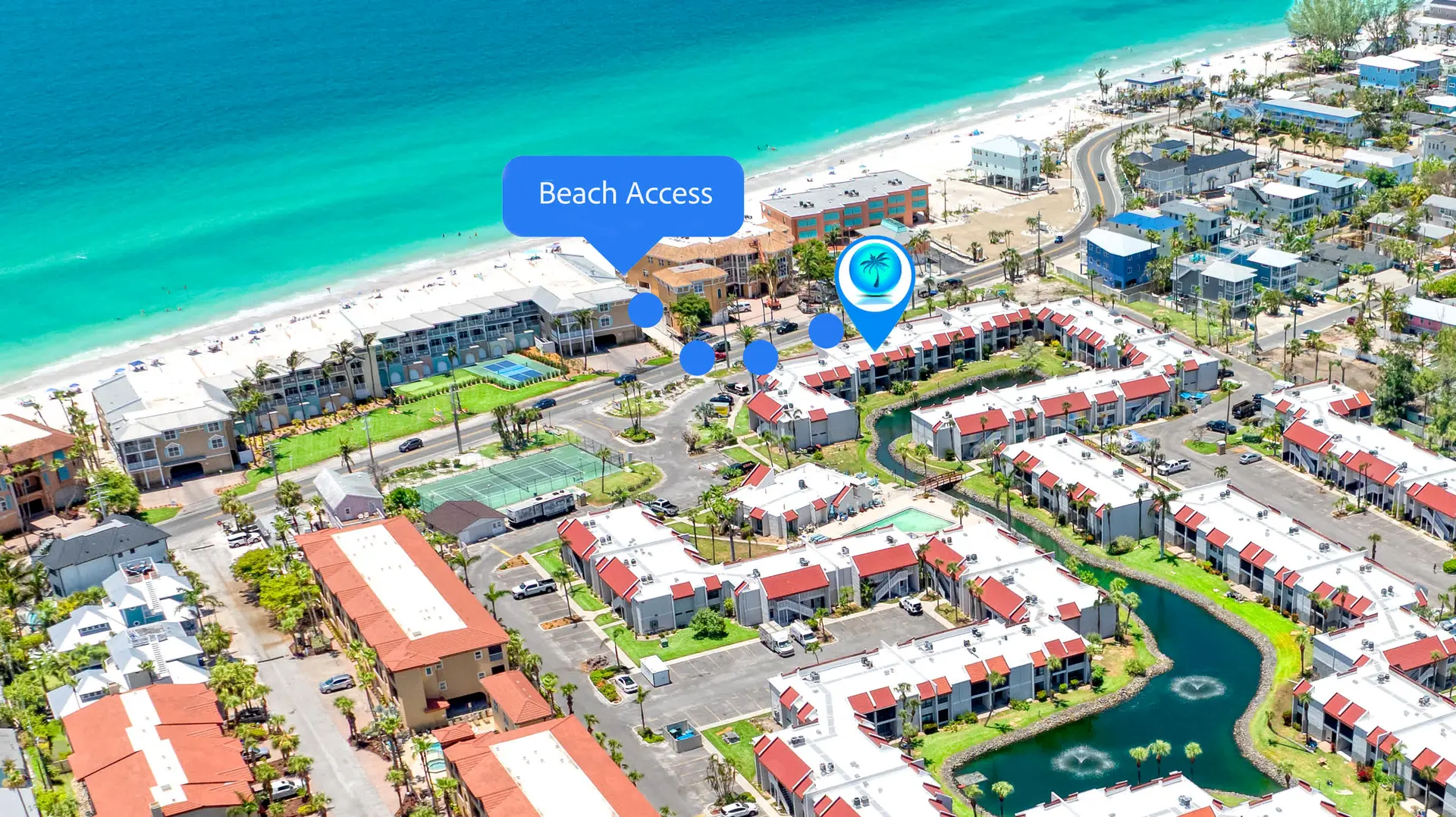 An aerial view of a coastal resort town with condos, a beach, and the ocean.