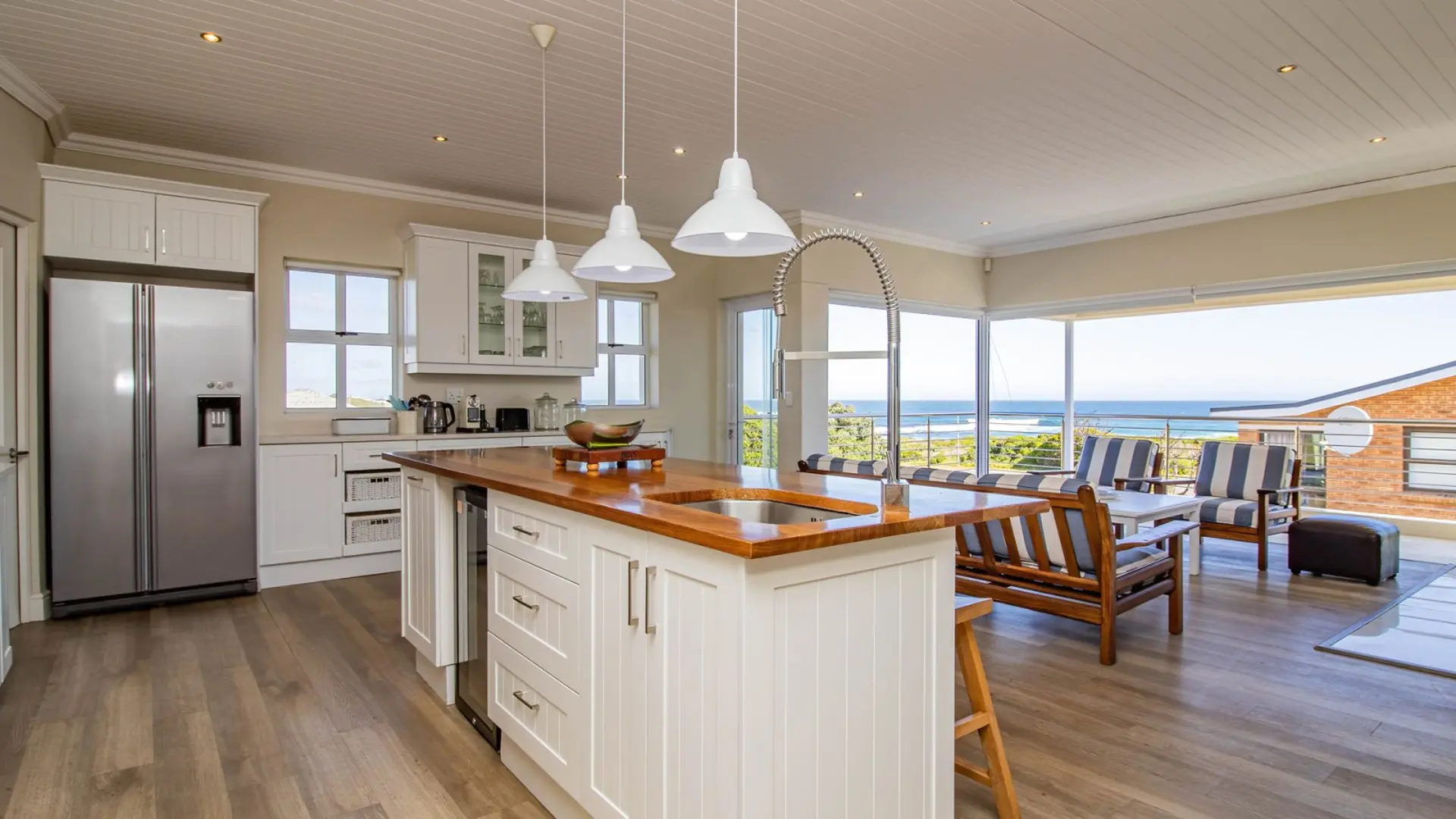 Kitchen with island and seating area with ocean view.