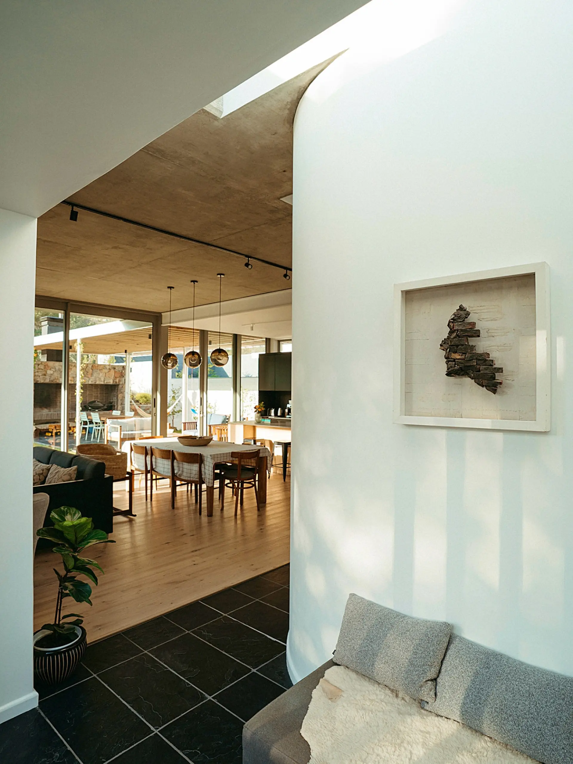 Modern living room with abstract art and a dining area.