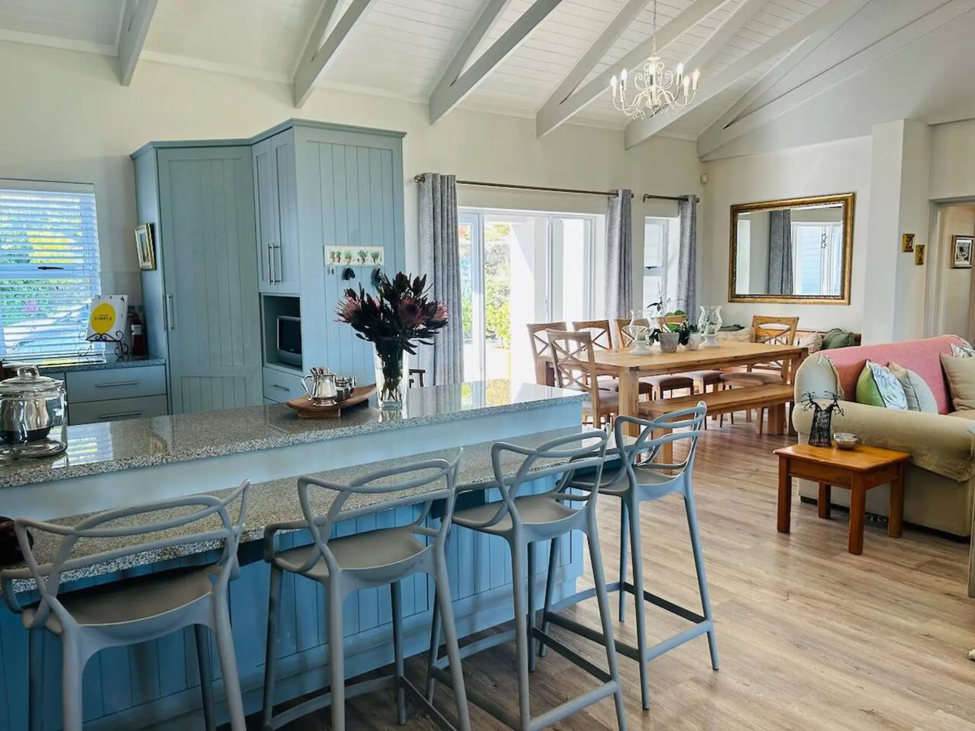 Kitchen and dining area with blue cabinets, island, and dining table.