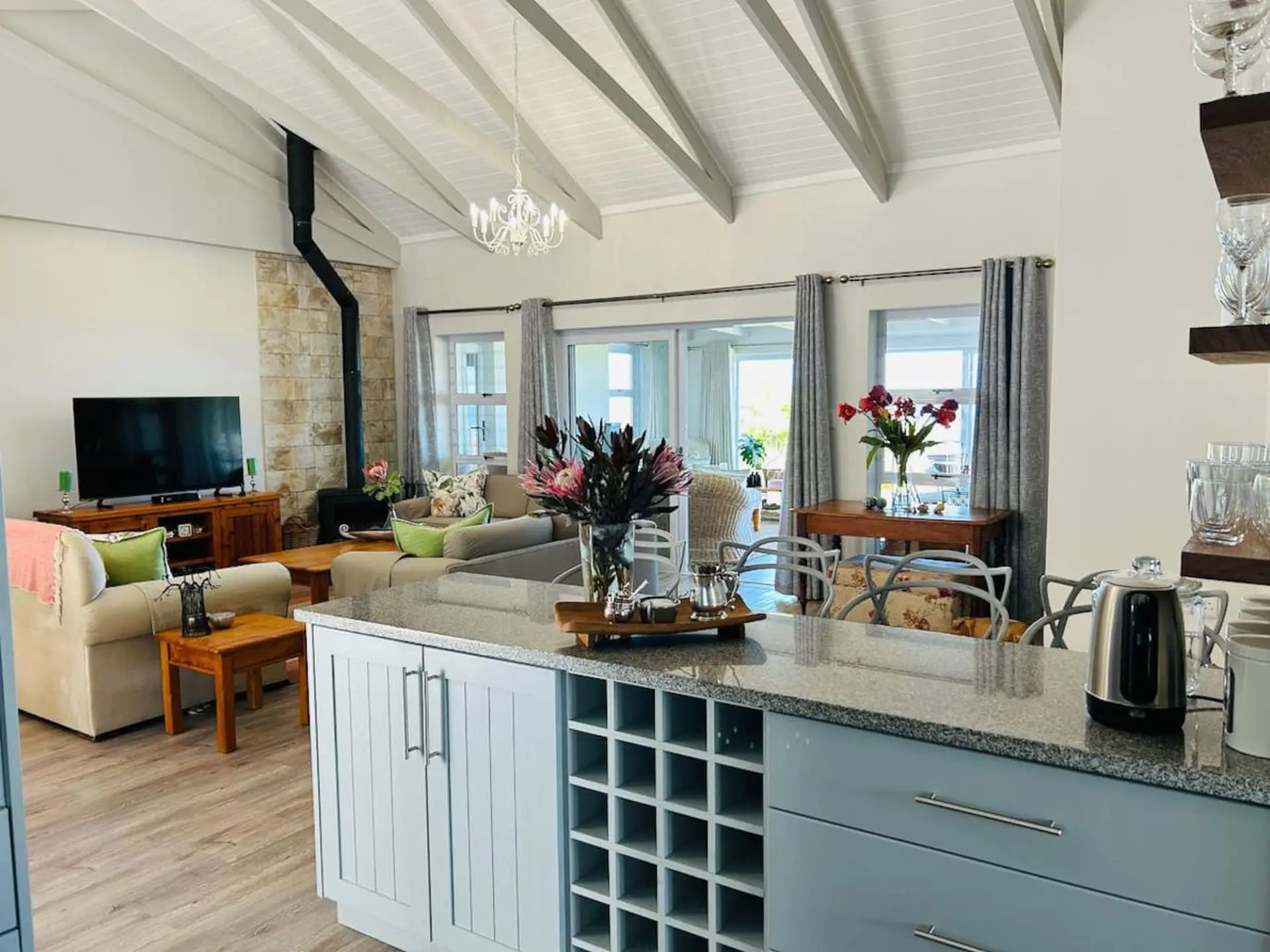 Living room and kitchen area with fireplace, couches, and island.