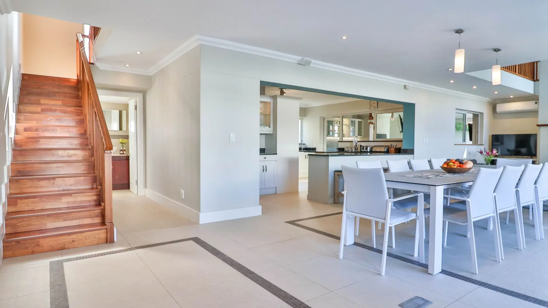 A spacious, modern dining and living area with a dining table and chairs.