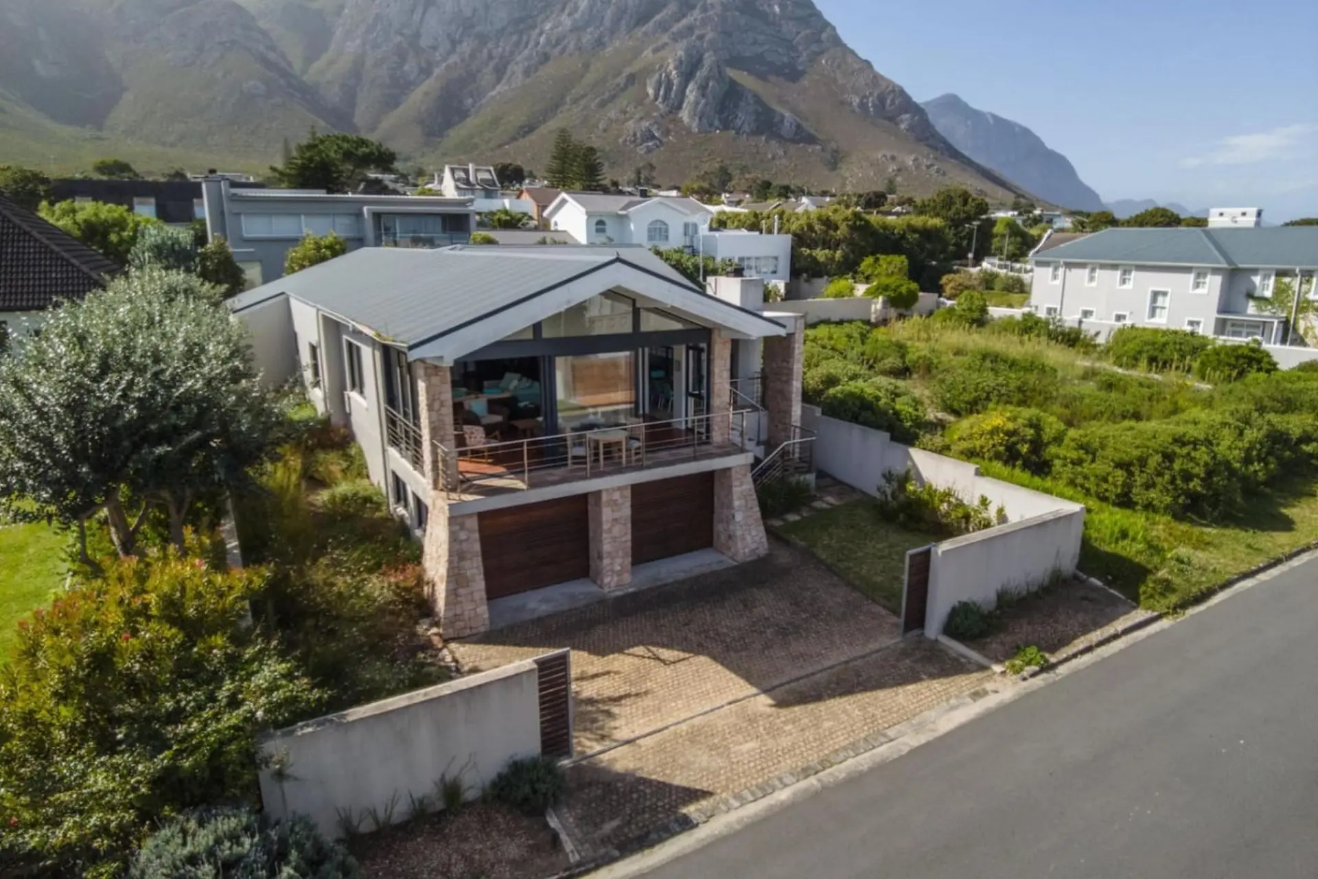 Modern house with mountains in the background.