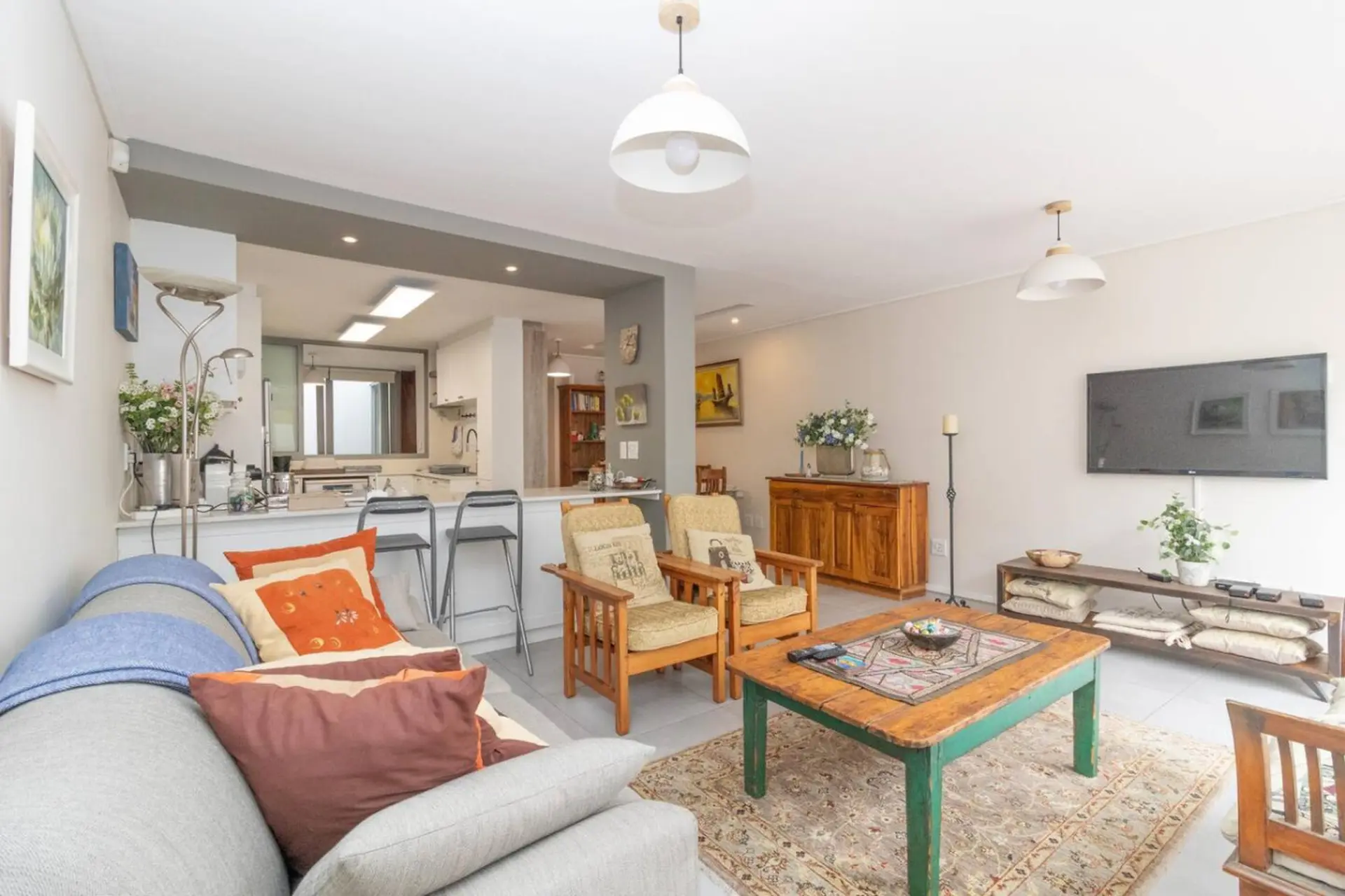 A living room with a couch, two armchairs, and a coffee table.