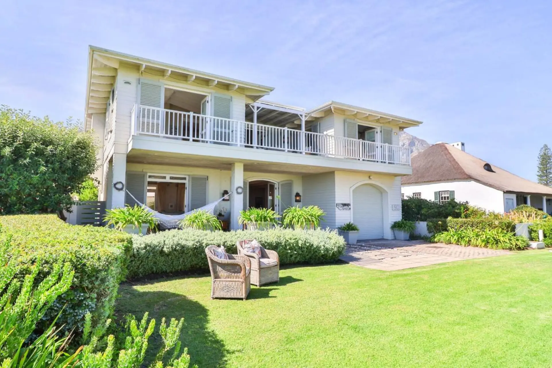 A two-story house with a balcony, porch, and garage.