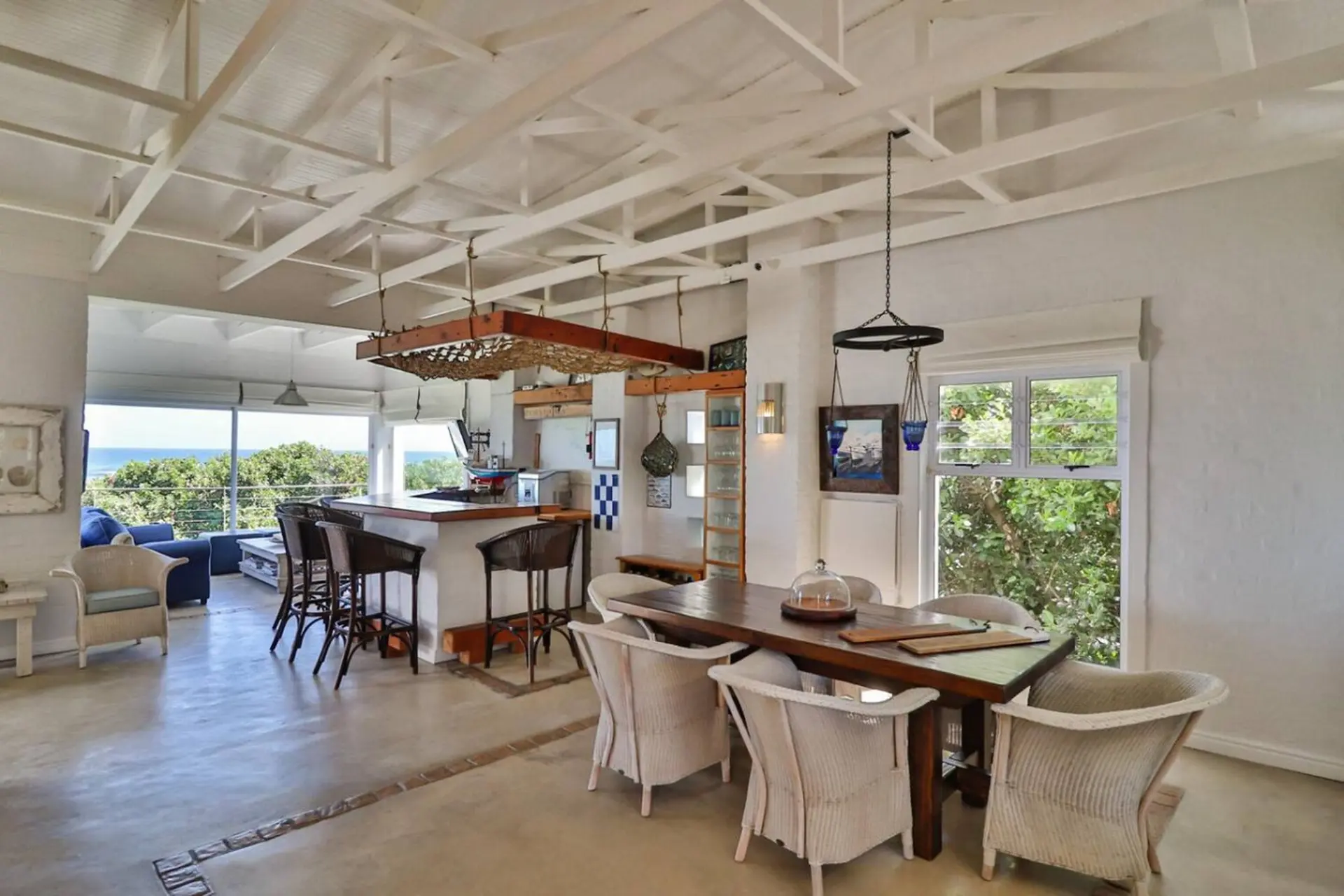 Rustic dining and bar area with ocean view.