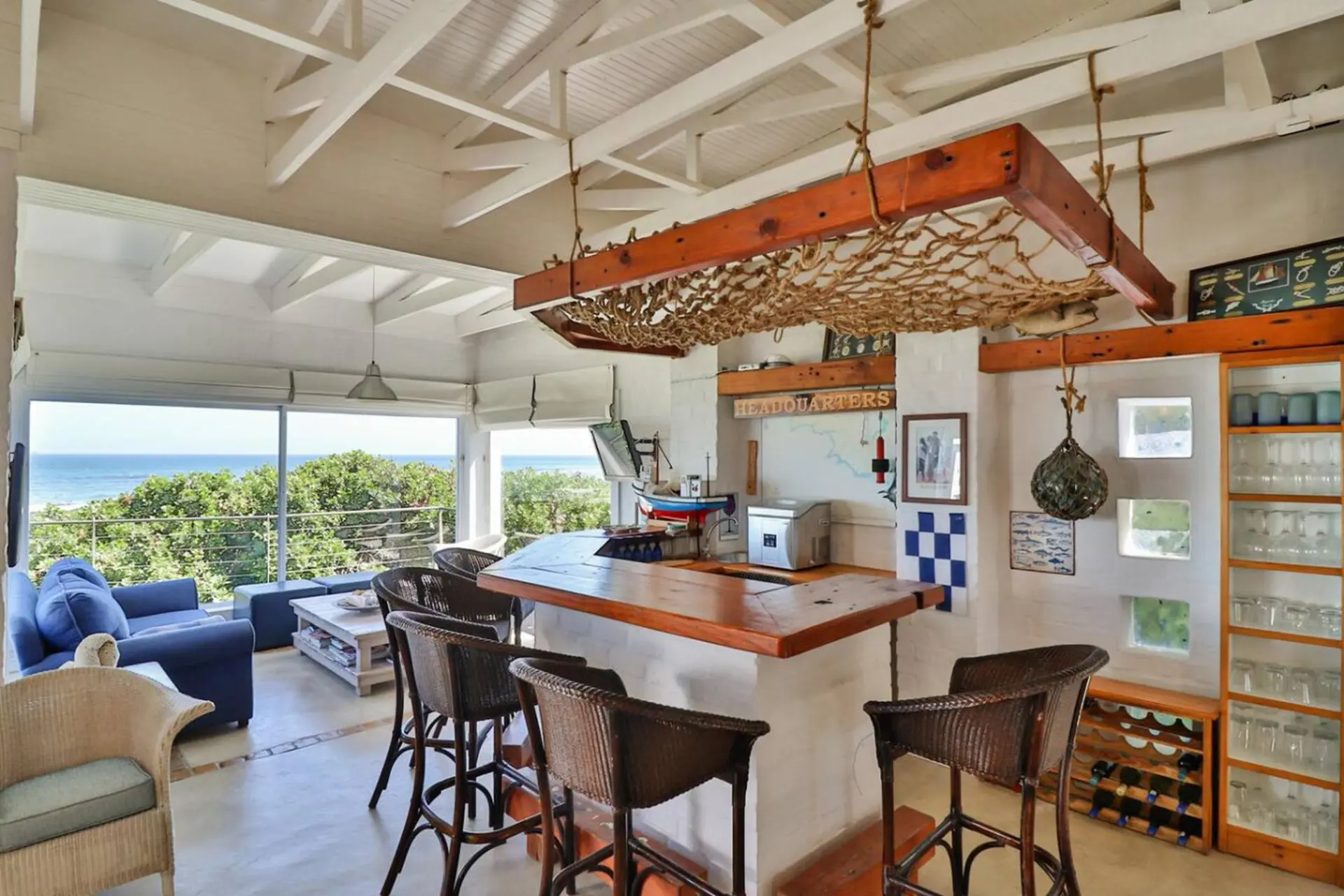 Bar area with ocean view and wicker seating.