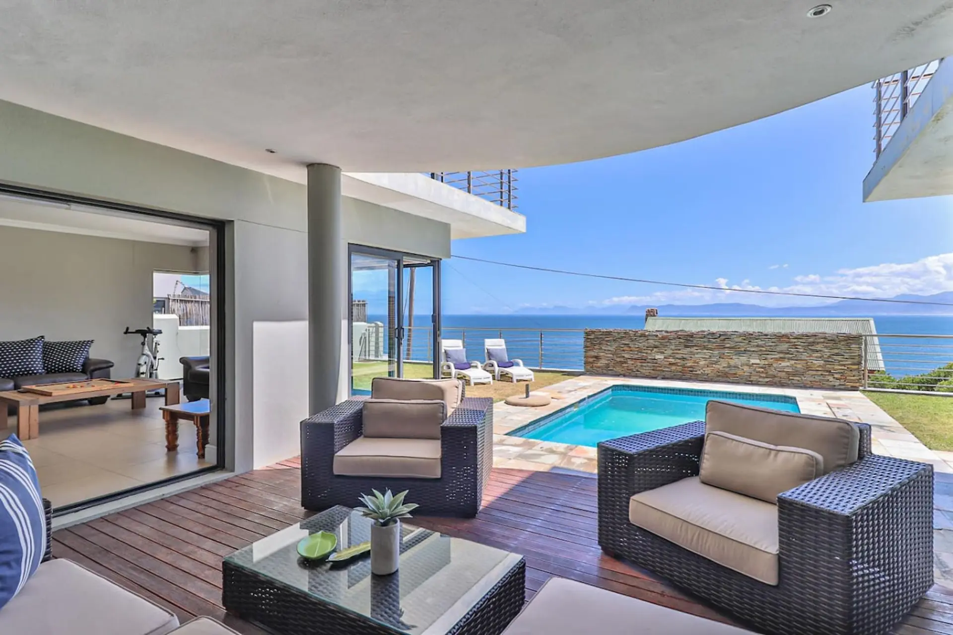Patio with swimming pool and ocean view.