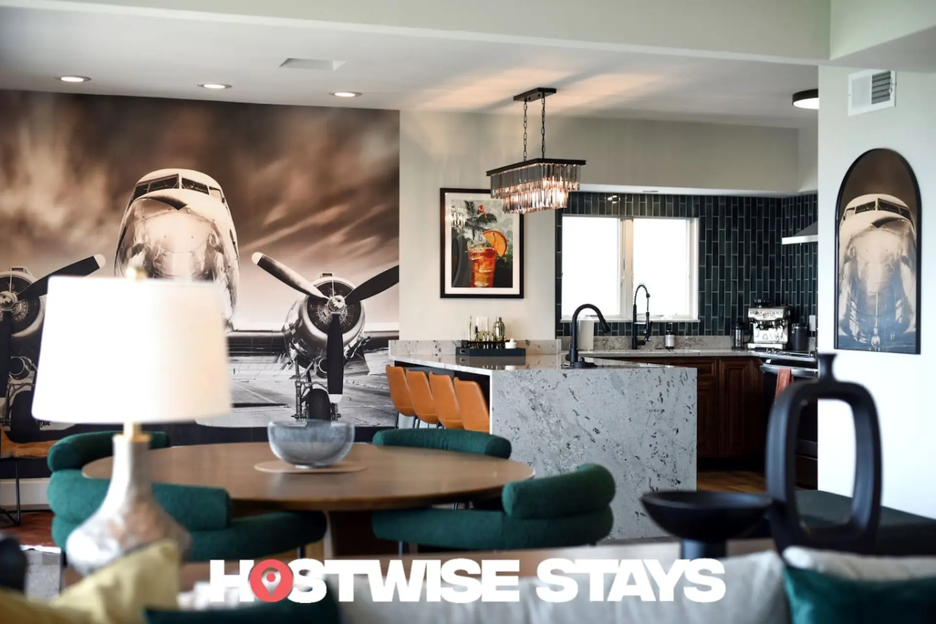 Modern dining and kitchen area with airplane murals and art.