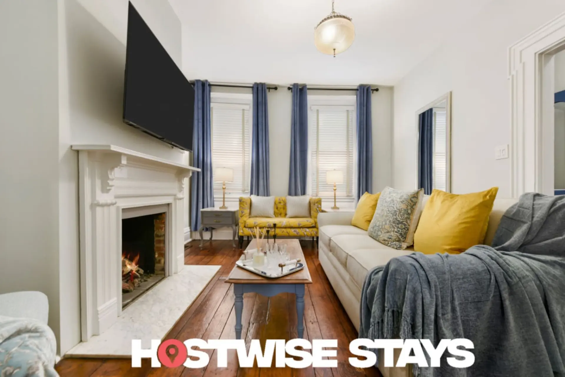 Living room with fireplace, sofa, armchair, and coffee table.