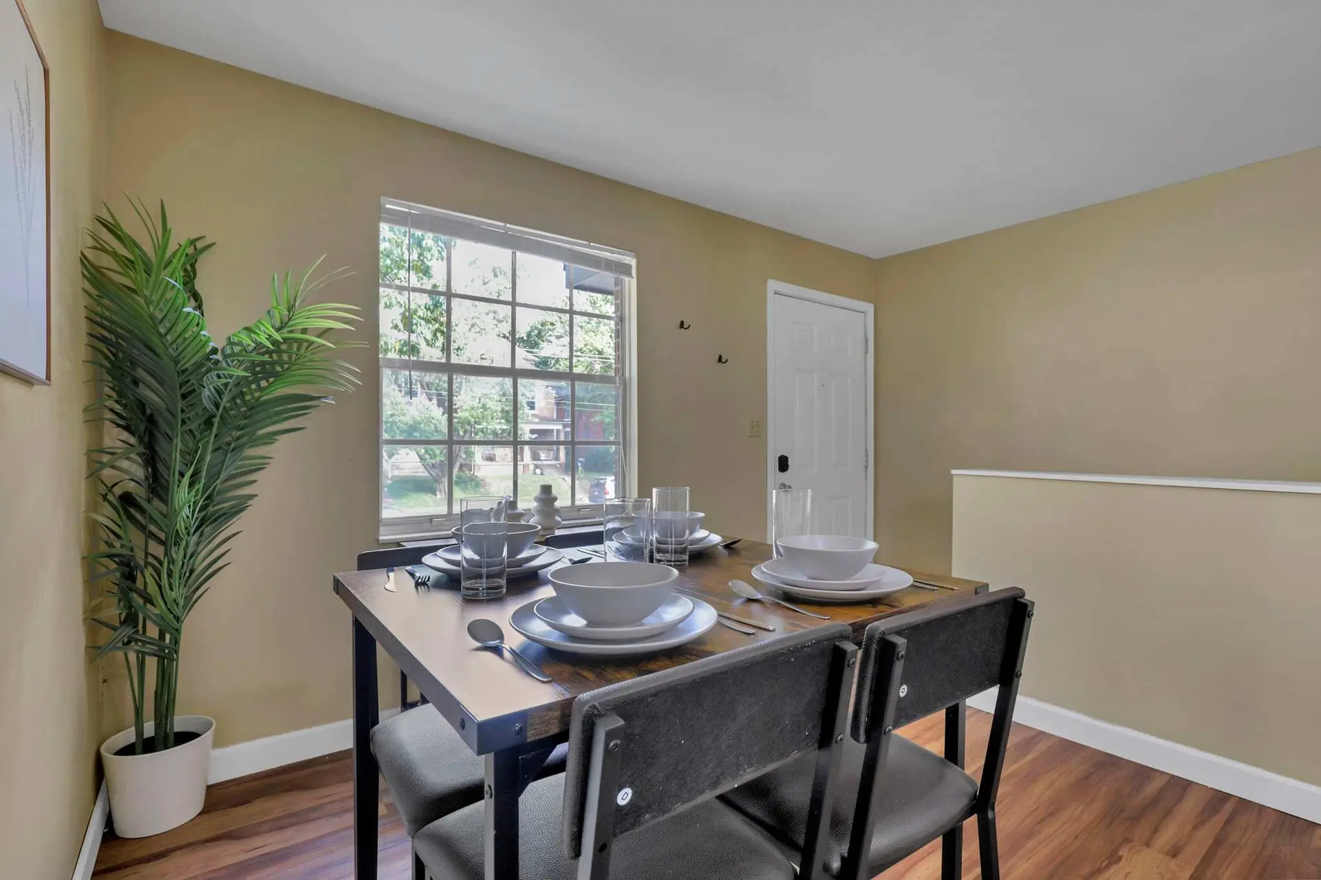 A dining table is set with plates, bowls, and glasses for a meal.