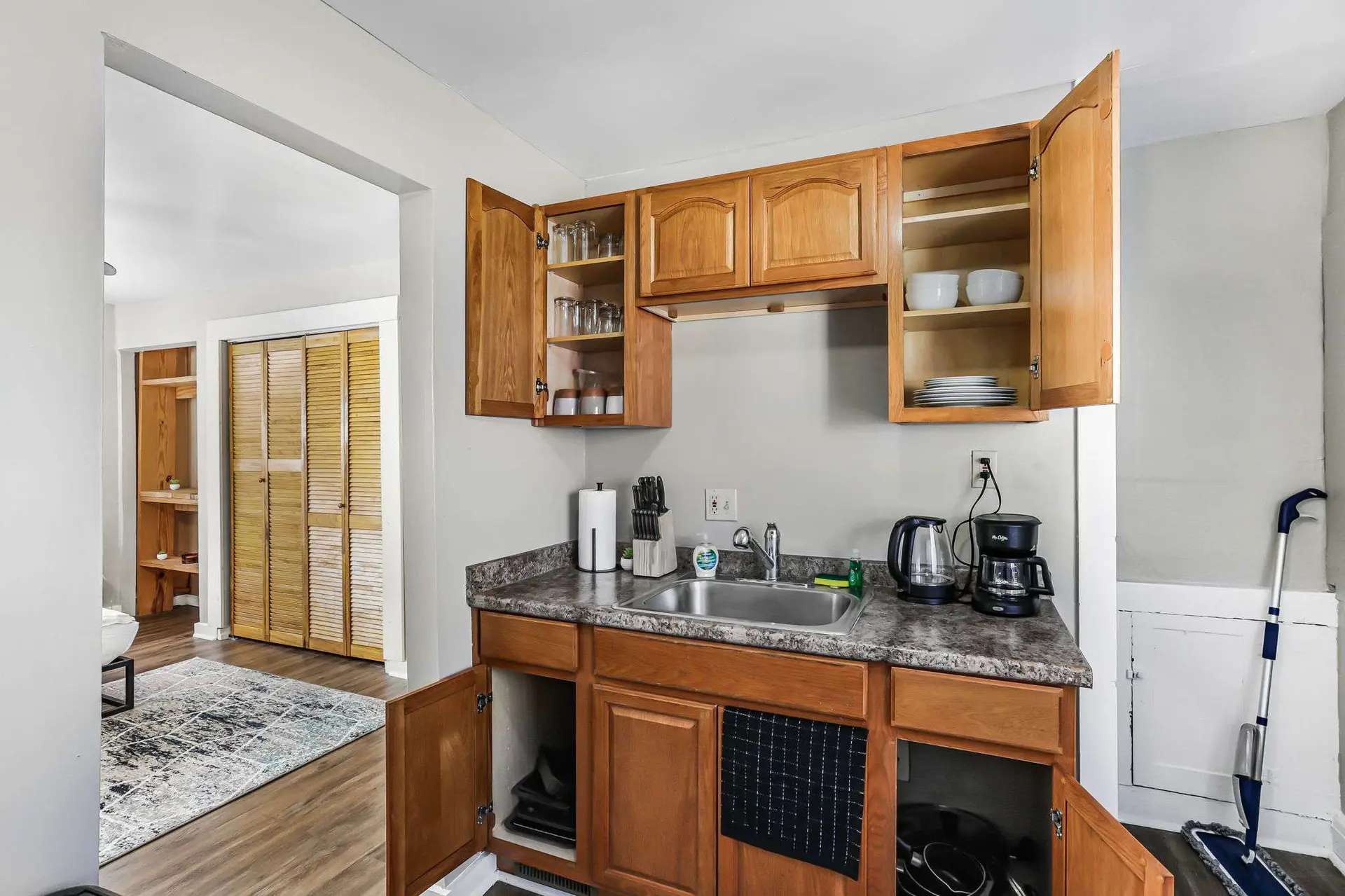 A small kitchen with wooden cabinets and appliances.