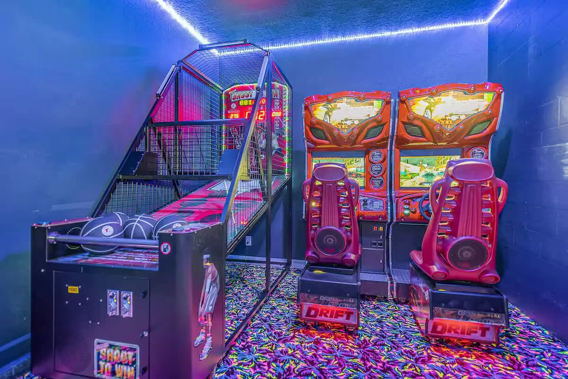 Arcade room with basketball game and racing games.
