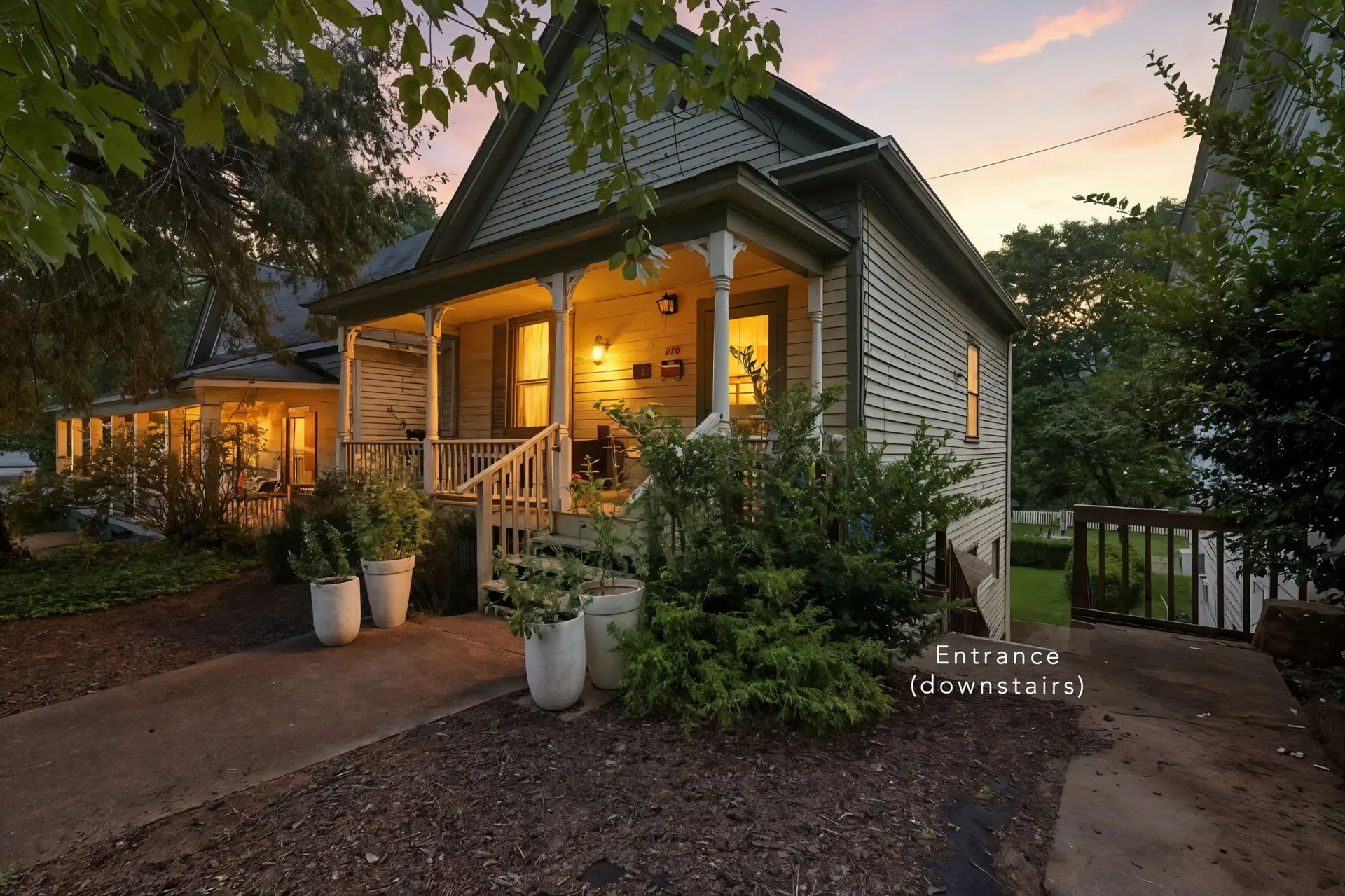 A charming house with a porch at dusk, lit by warm lights.
