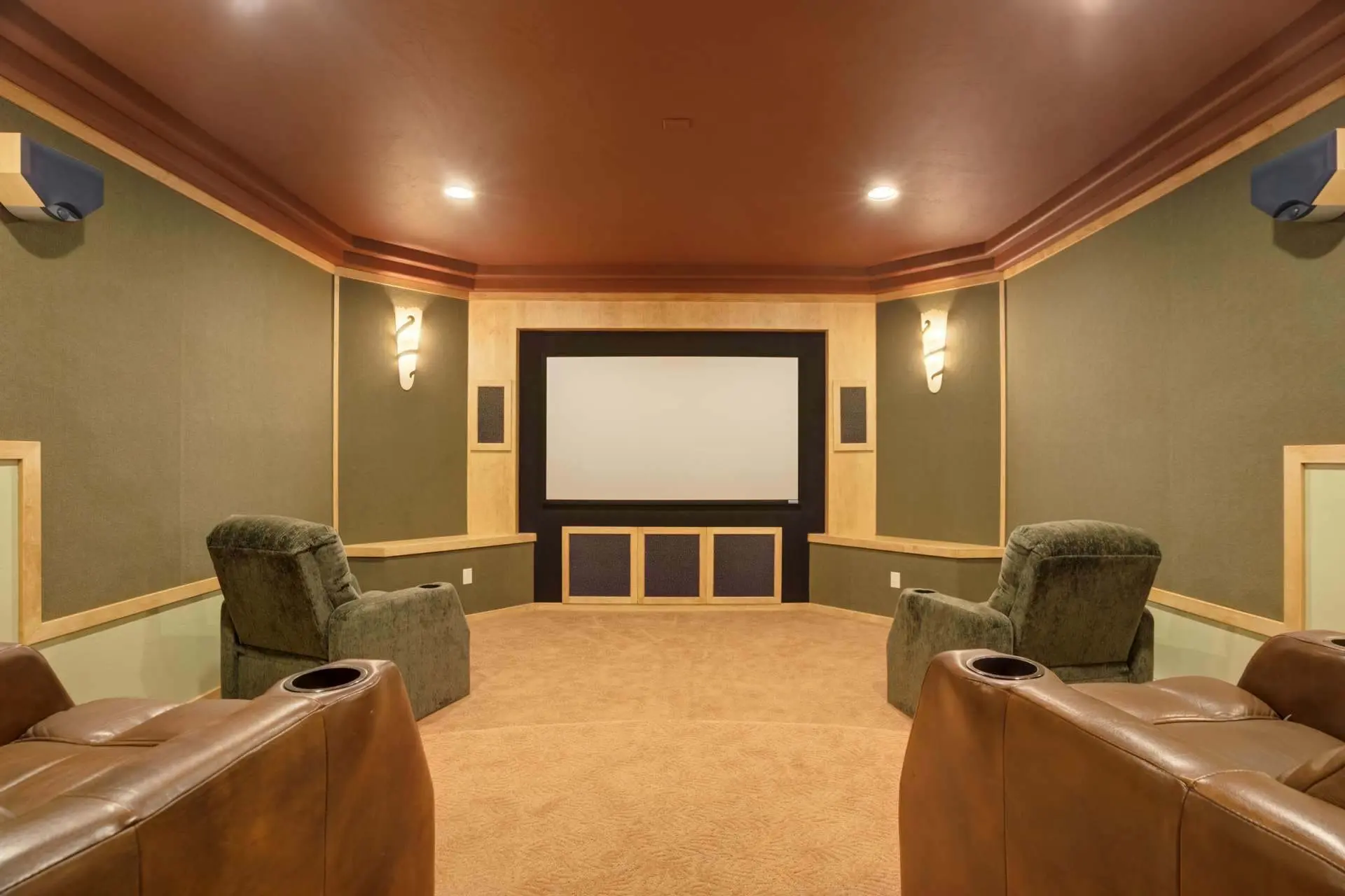Home theater with plush seating and a large screen, ideal for movie nights.