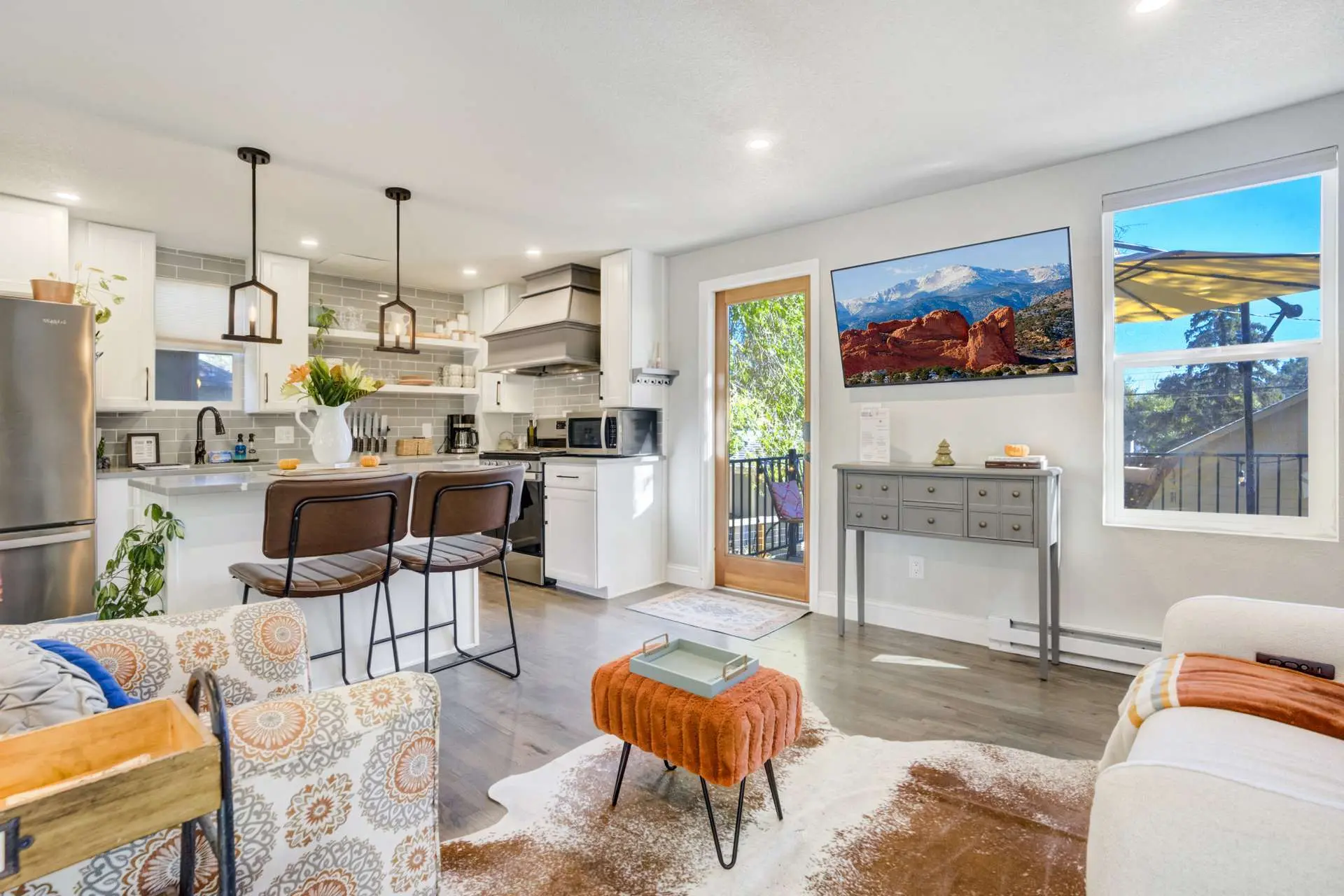 A living room and kitchen area with island seating.