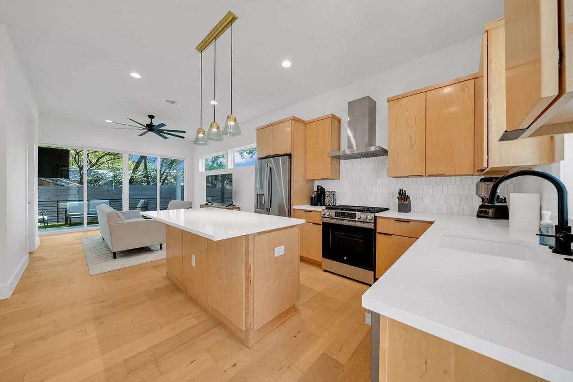 Kitchen with a sleek stove, island, and stainless steel appliances.