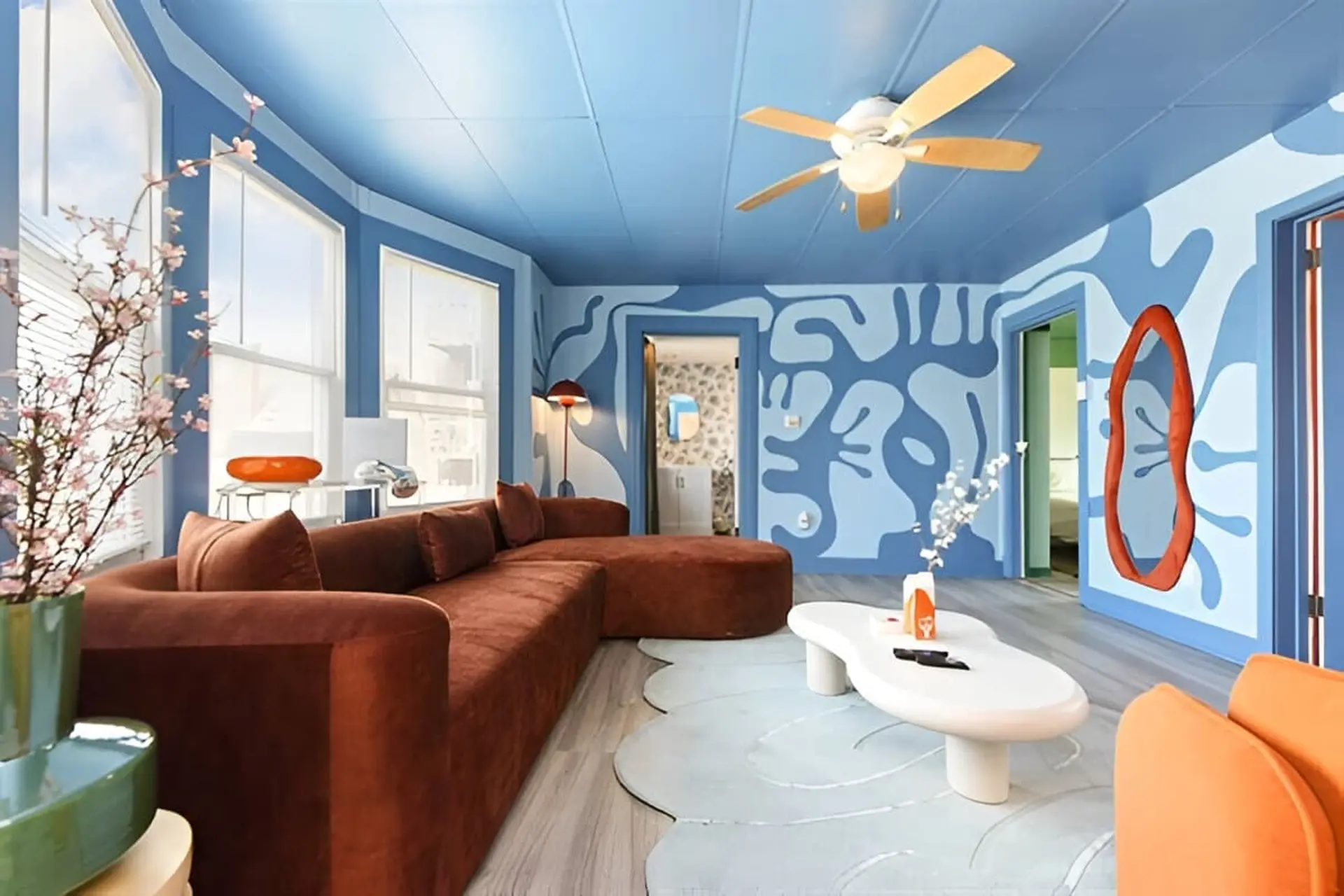 A living room with a blue and white abstract pattern on the walls.