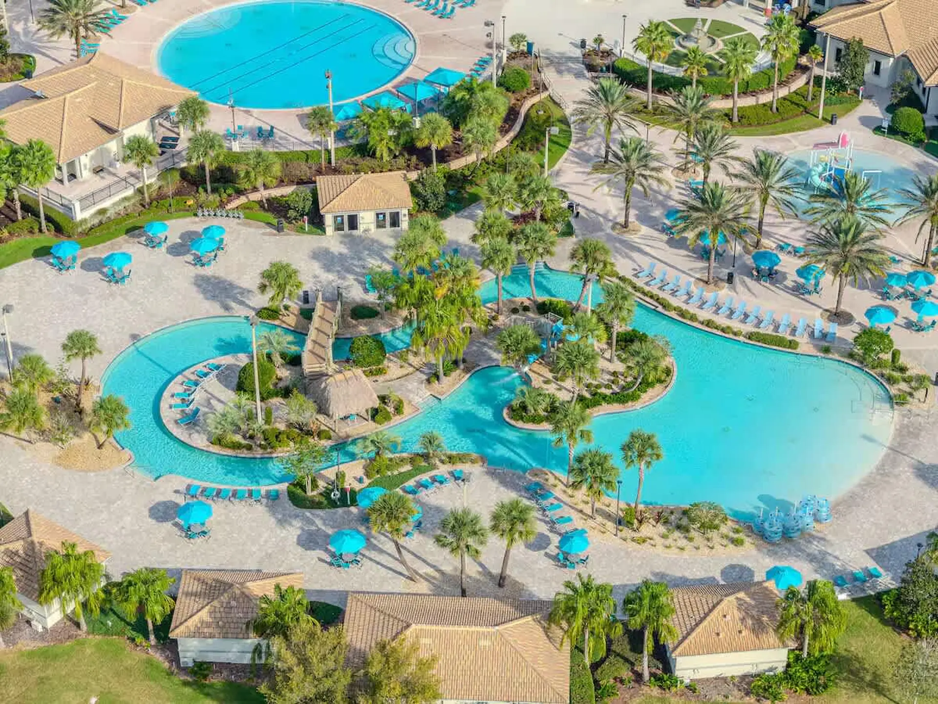 Aerial view of resort with multiple pools, water slides, and cabanas.