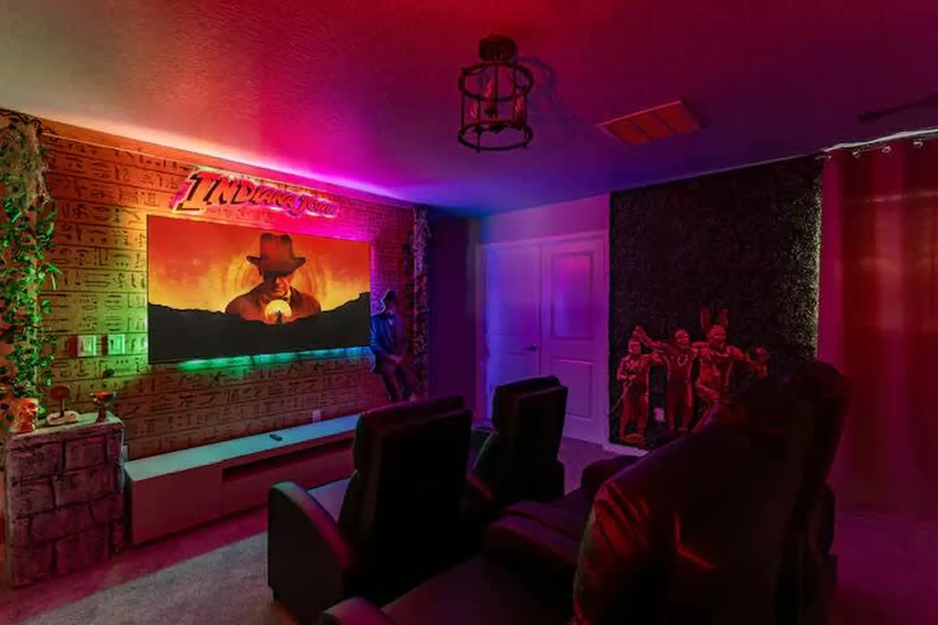 An Indiana Jones-themed home theater with themed decor, seating, and lighting.