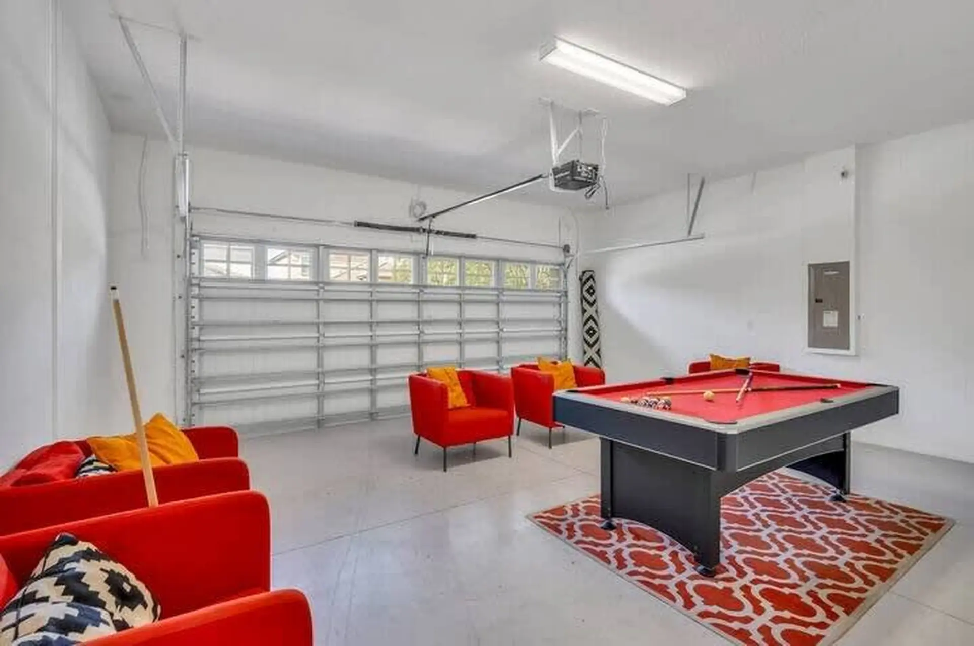 **A spacious garage with a pool table and seating.**