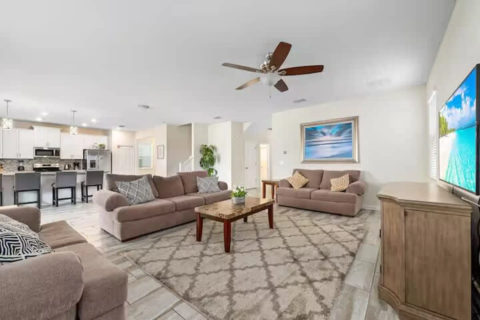Living room with couches, a coffee table, and a TV.