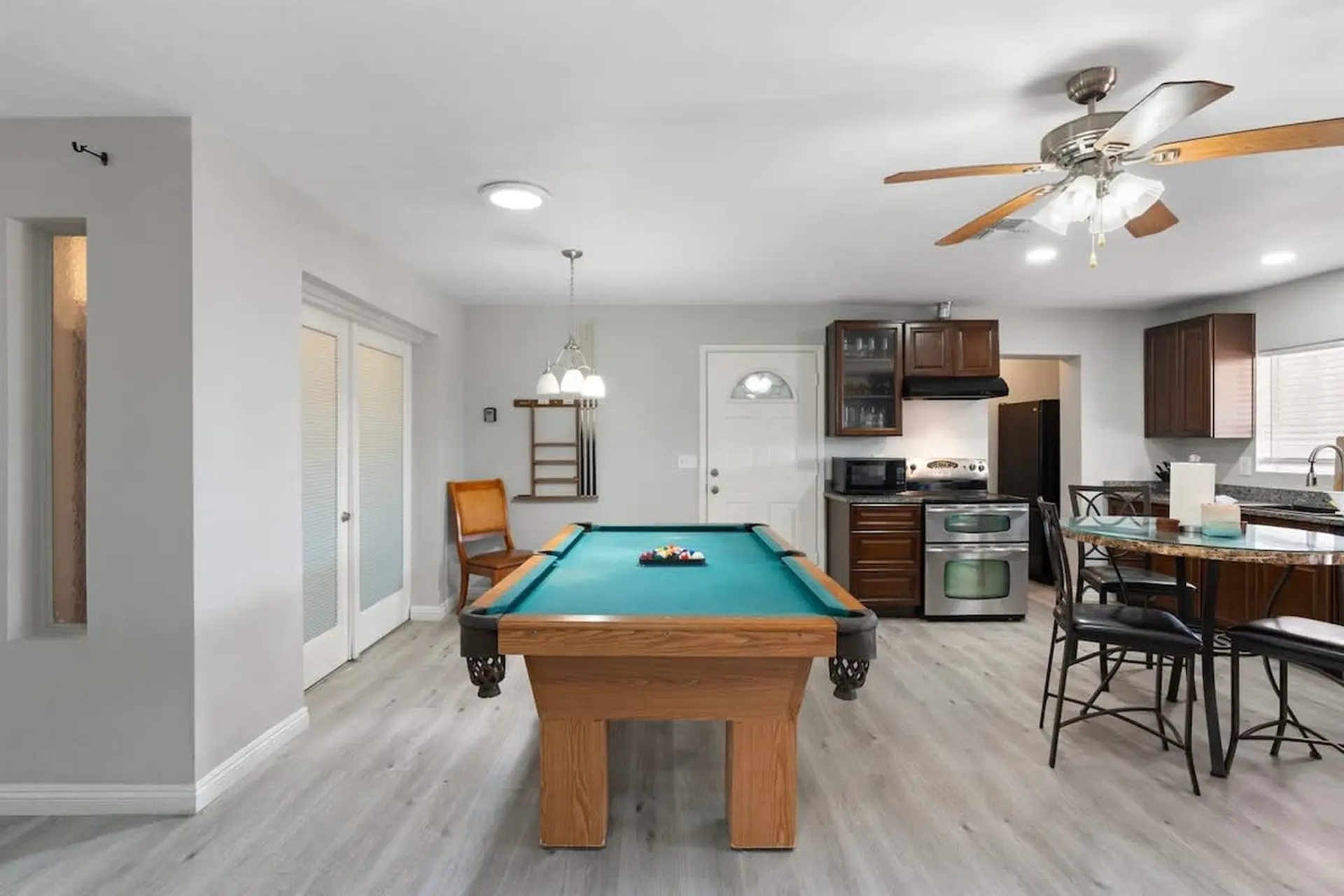 A pool table and dining area are visible in this room.