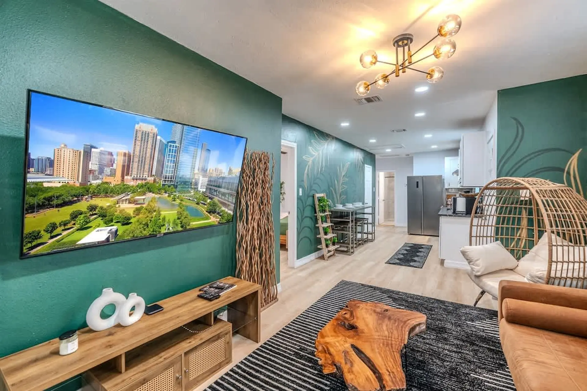 A modern living room with a large TV, wooden furniture, and unique decor.