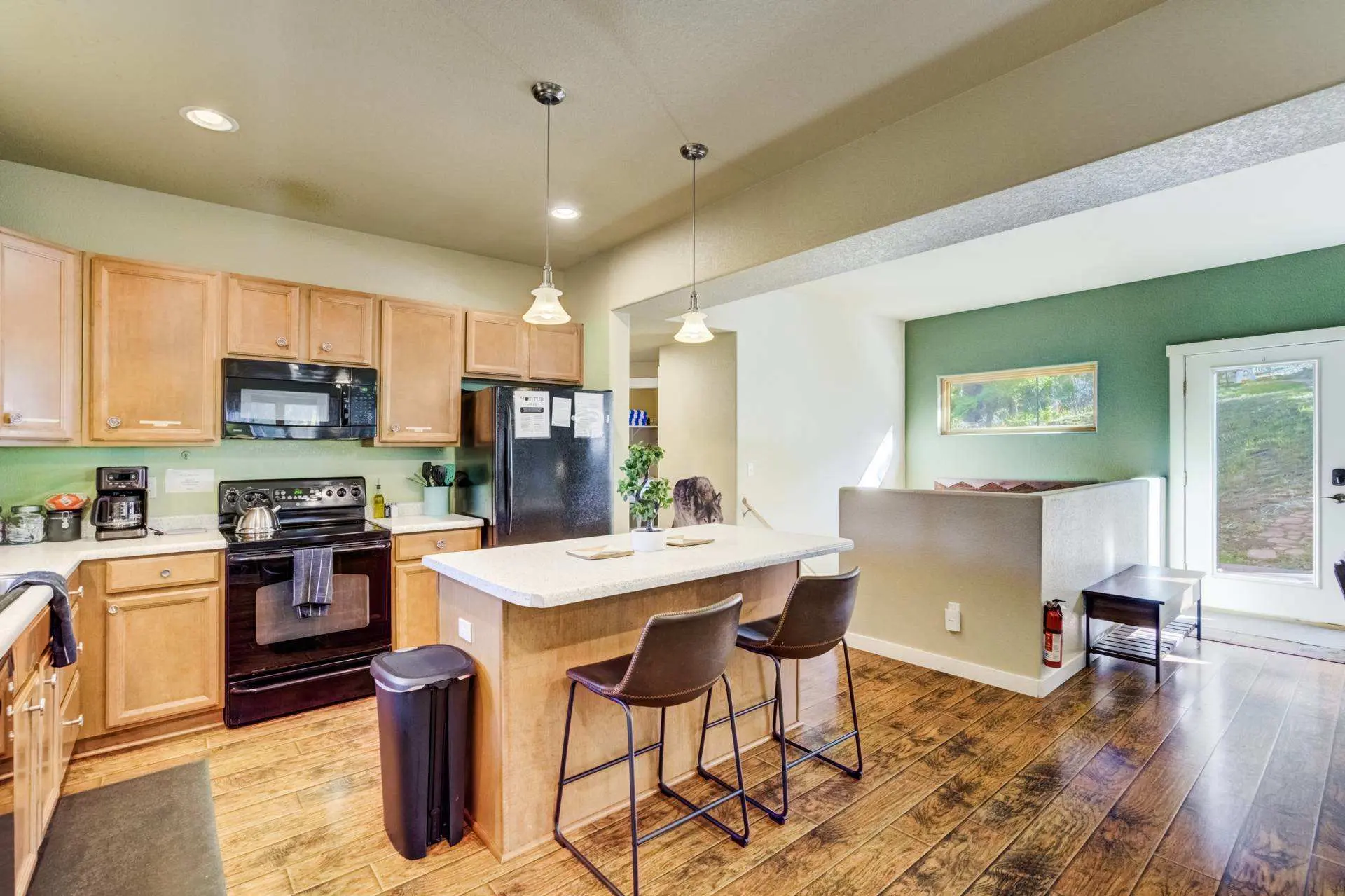 Kitchen island with bar stools in a wood-accented kitchen.