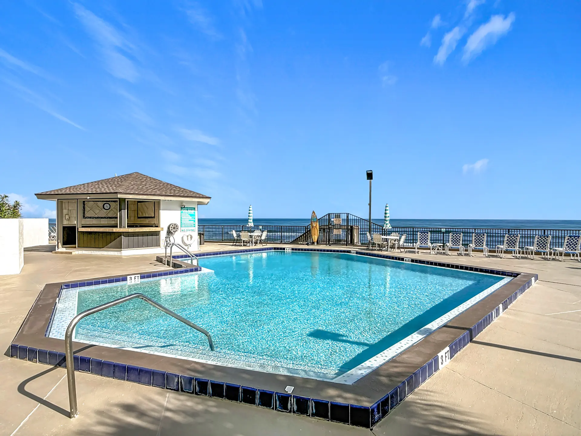 A rectangular pool with blue tiled edges and a shallow end marked "3 FT".