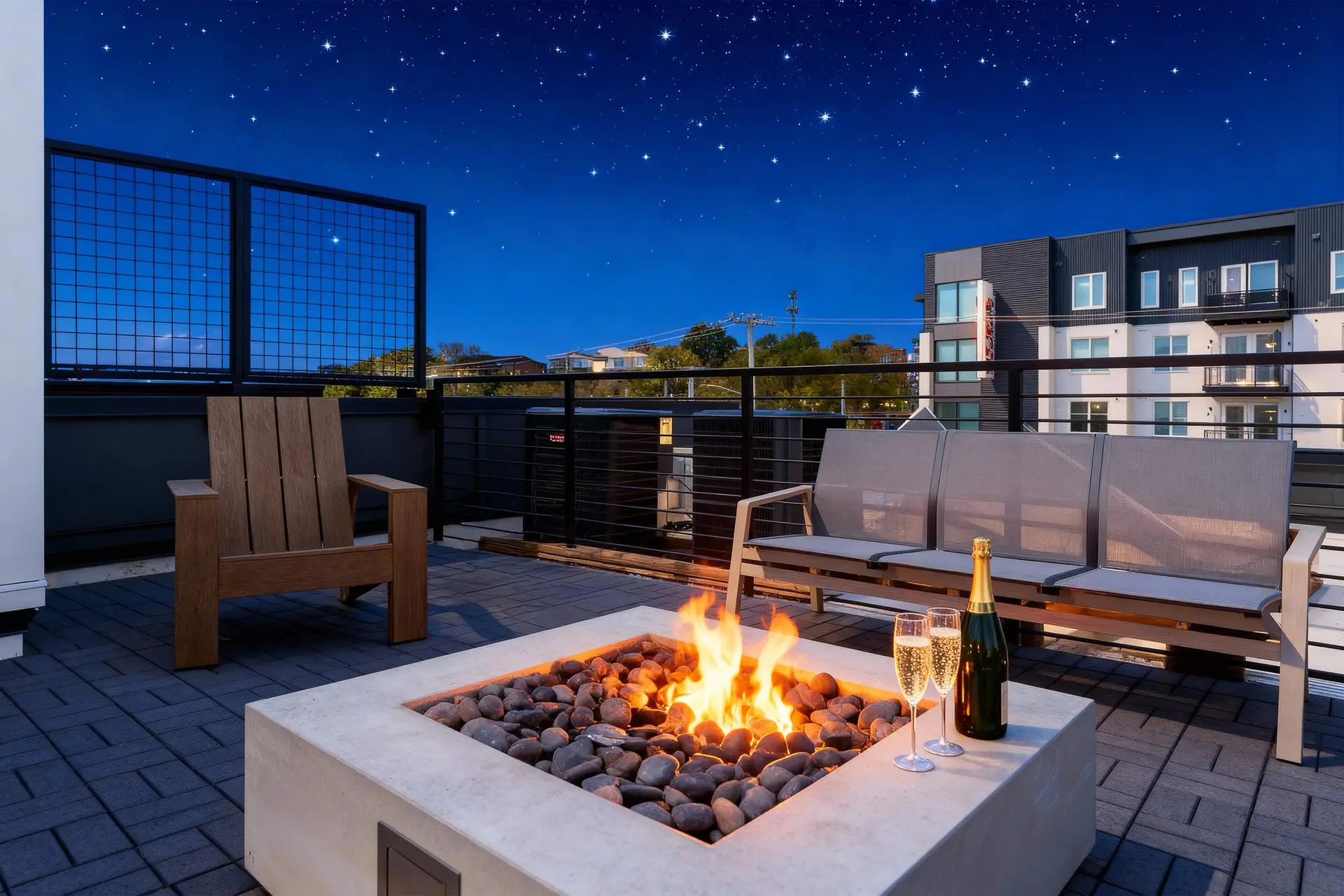 Rooftop patio with a fire pit, champagne, and a starry night sky.