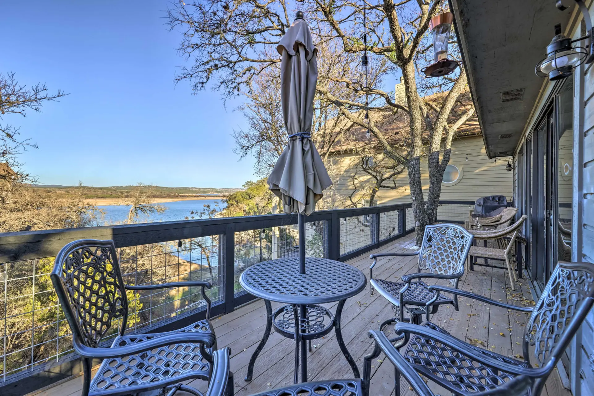 Deck with lake view, chairs, and table.