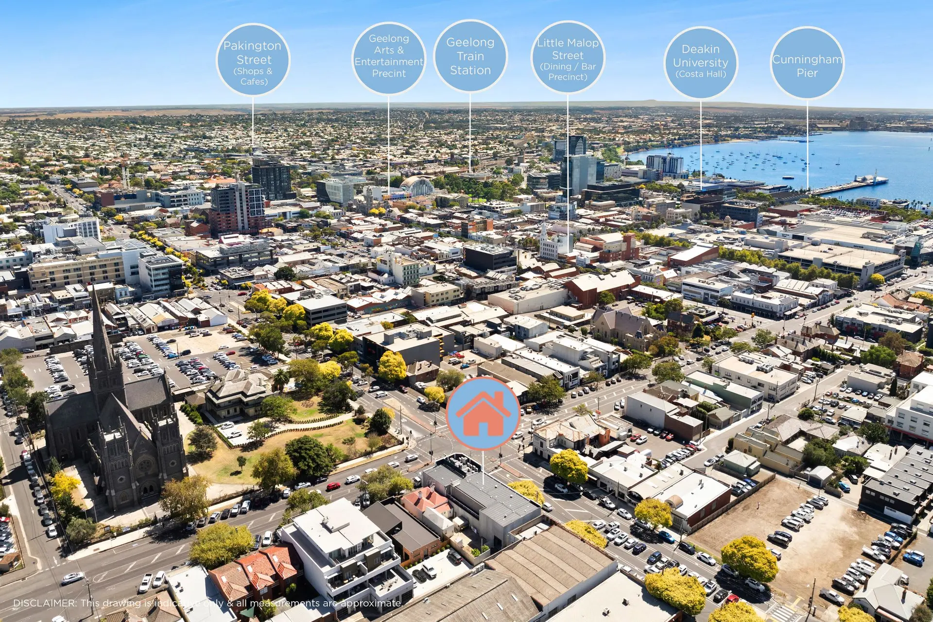 Aerial view of a city with buildings, streets, and a bay.