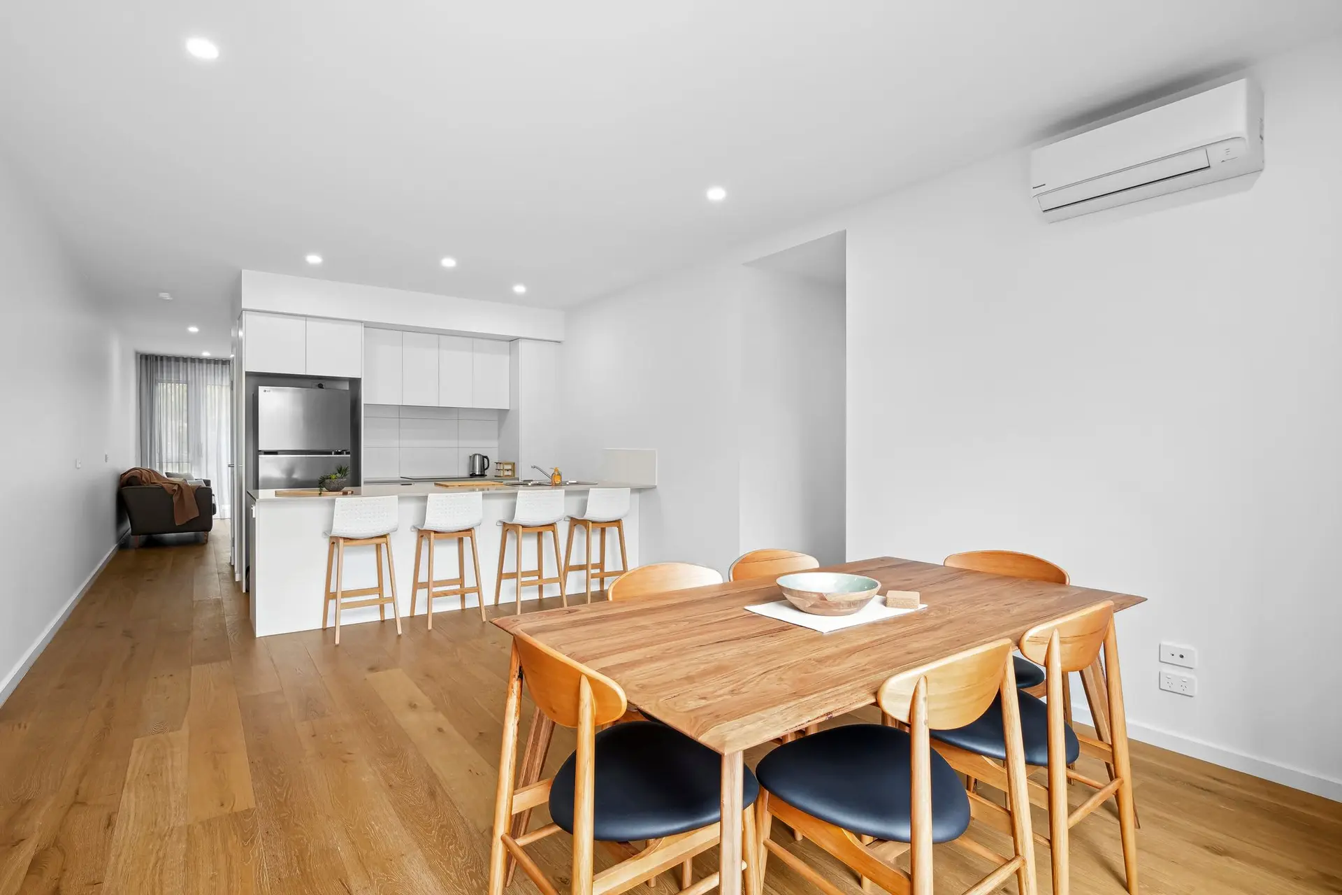 Dining set with wooden table and chairs in a modern kitchen.