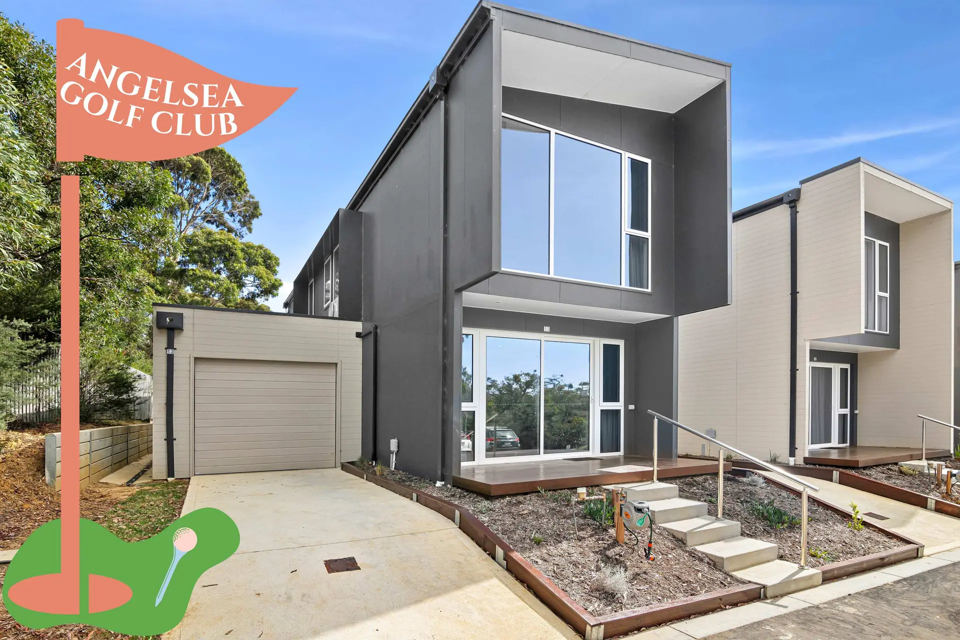 A modern house with a golf-themed flag.