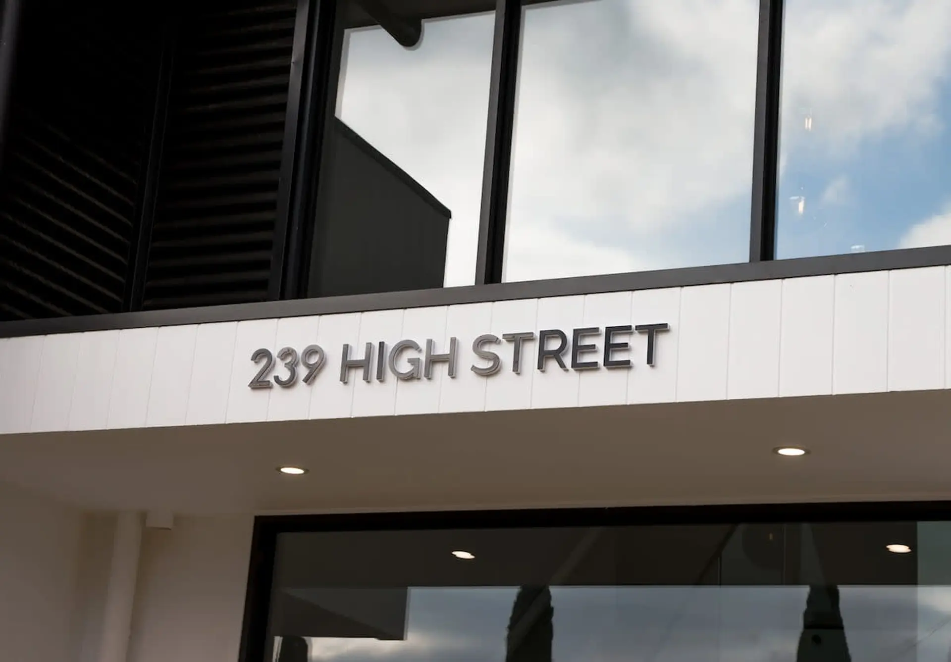 The text "239 HIGH STREET" is displayed in metallic letters on a white facade.