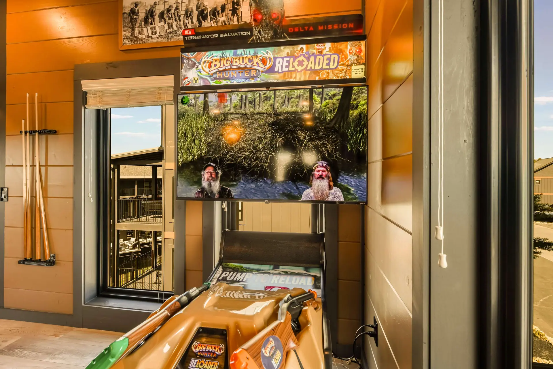 An arcade gun game with a screen showing Big Buck Hunter Reloaded.