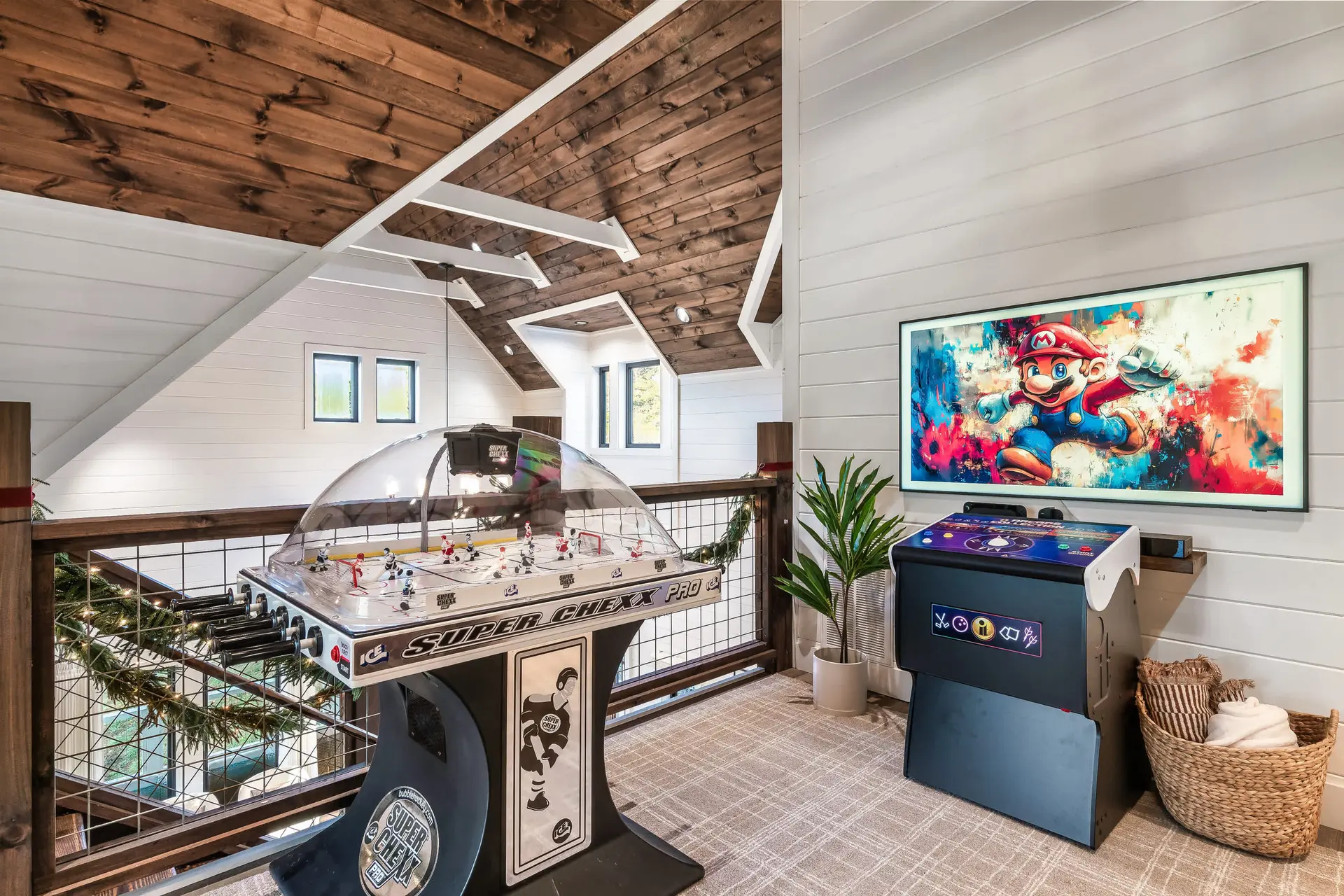 A room with a Super Chexx Pro bubble hockey table and an arcade game.