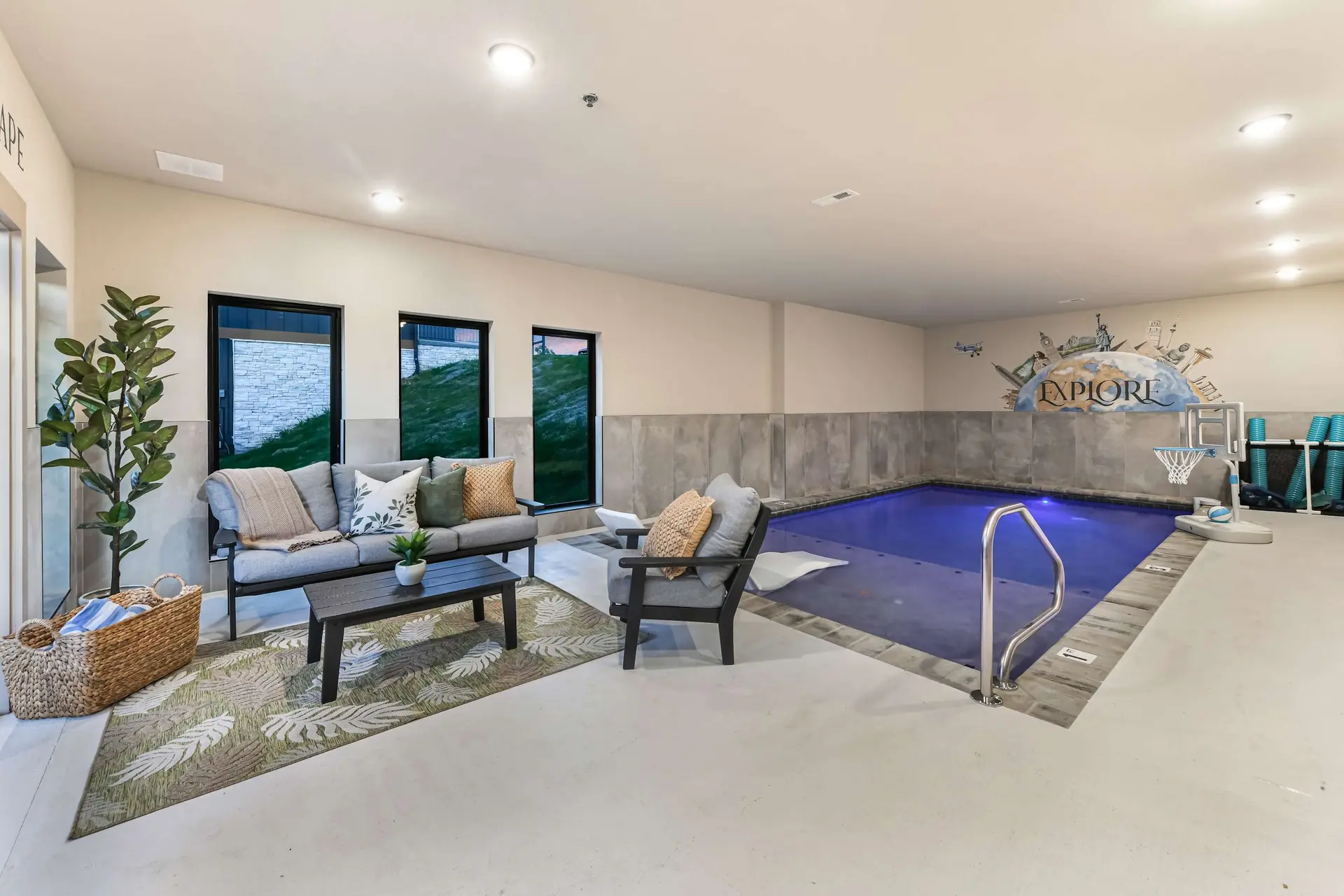 Indoor pool with seating area and a mural of landmarks.