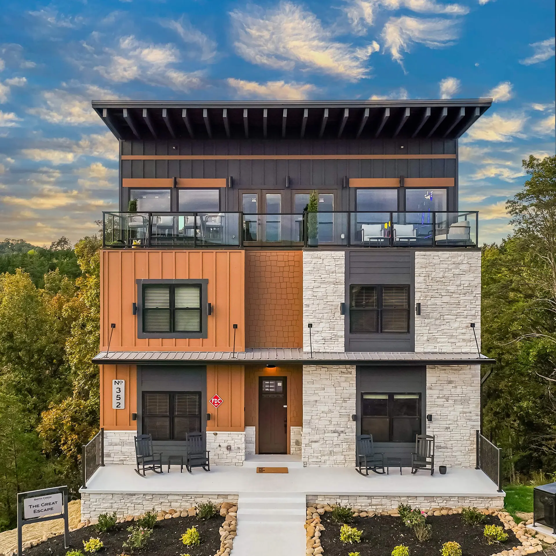 Modern home with multi-level balconies and stone accents.